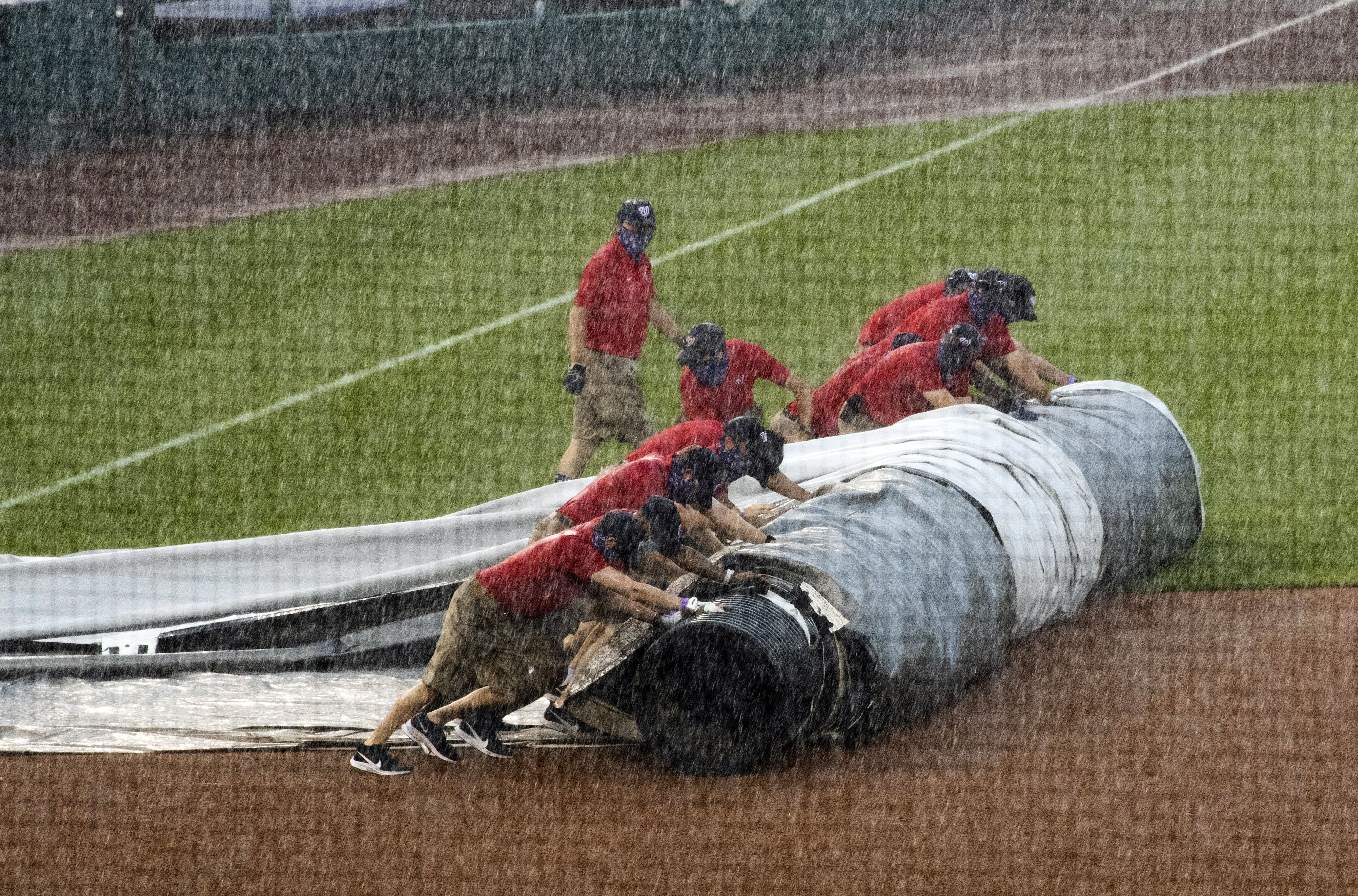 Strasburg's debut shaky; O's-Nats suspended by tarp issues