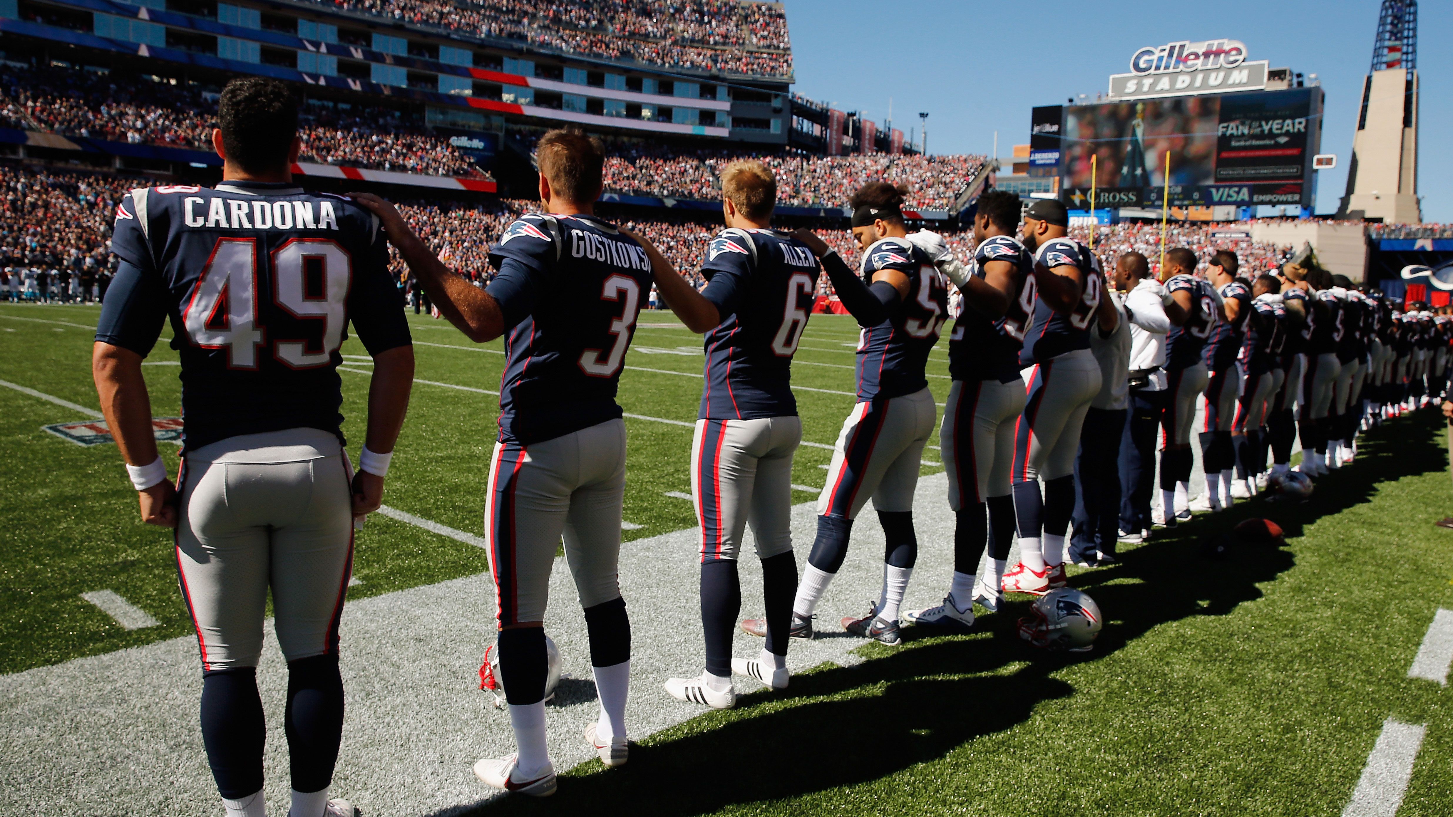 New England Patriots stand during national anthem before Panthers game