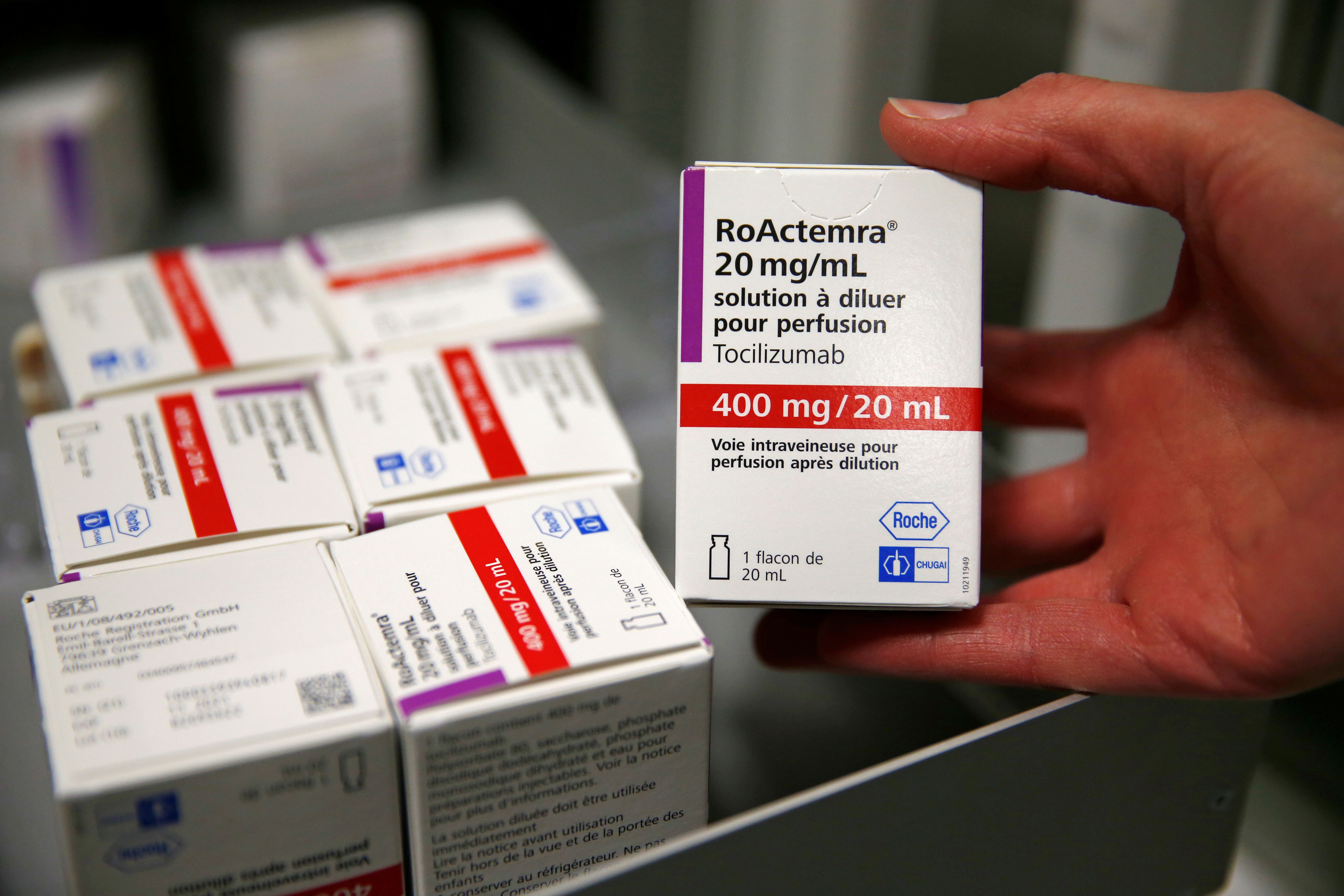 A pharmacist displays a box of tocilizumab at the pharmacy of Cambrai hospital