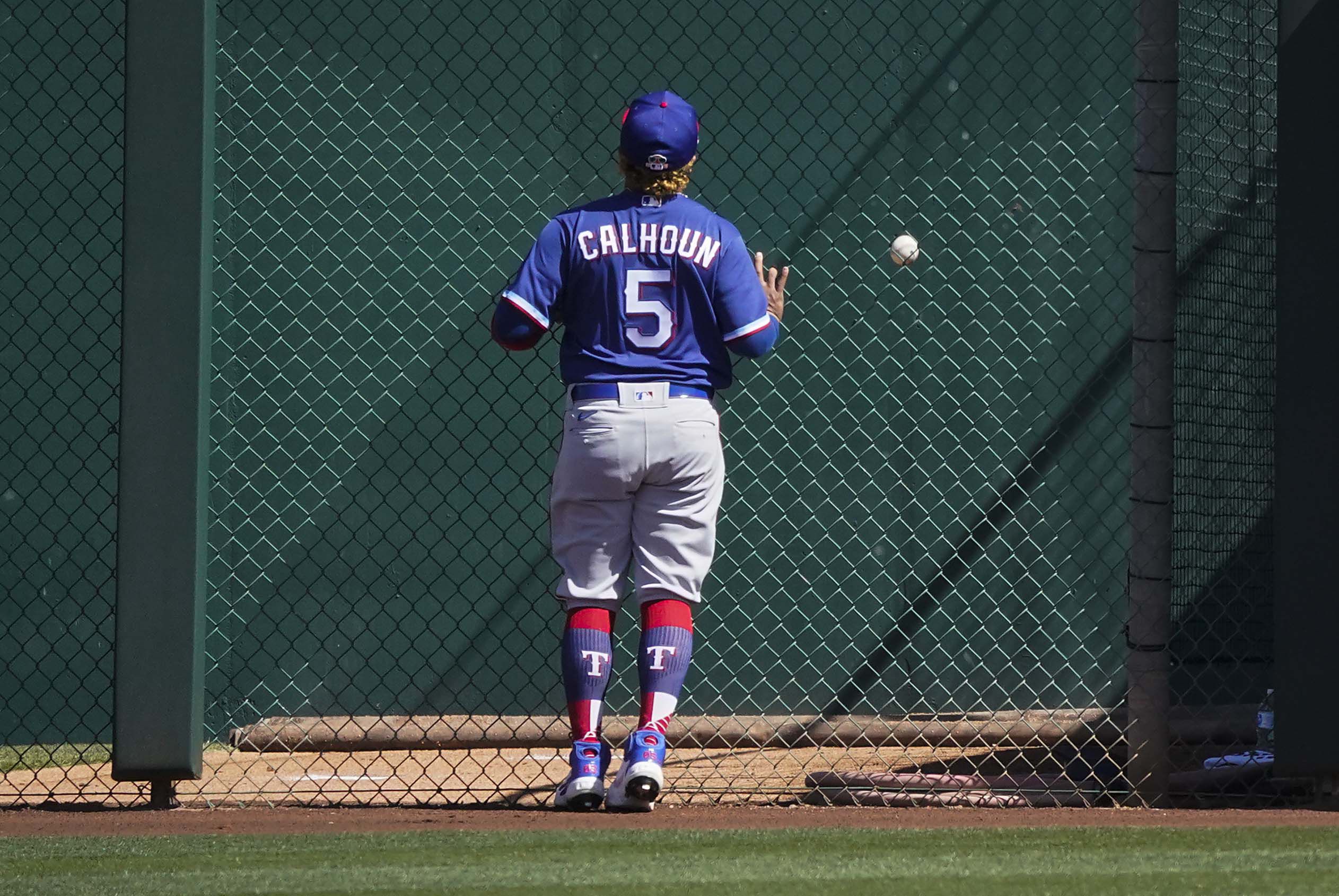 Texas Rangers third baseman Brock Holt (16) blows a bubble during