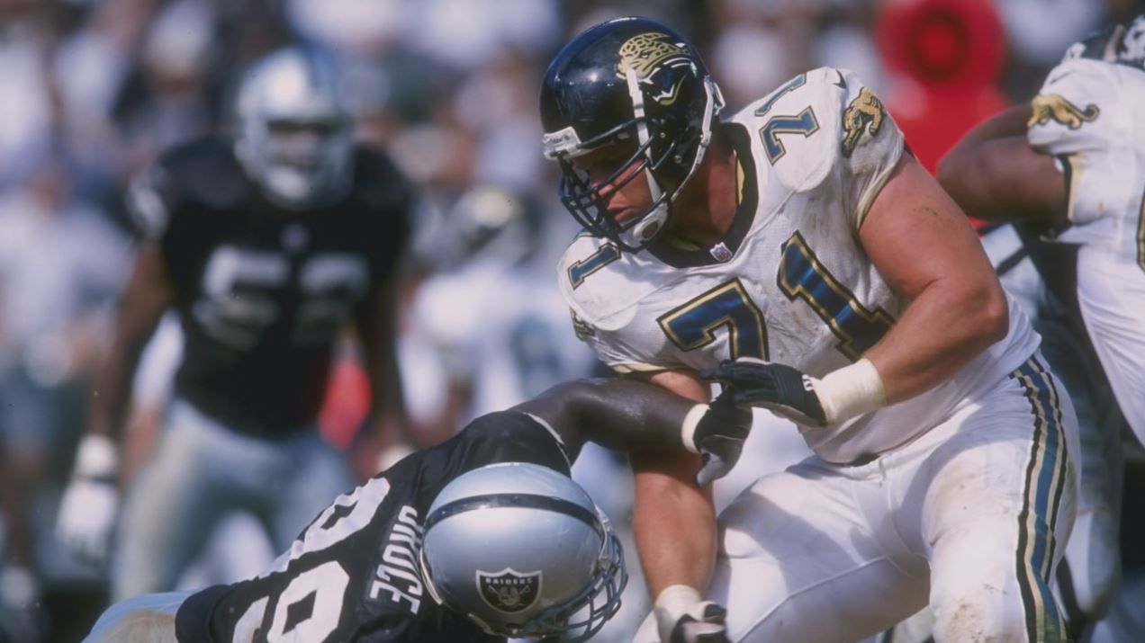 Former Jacksonville Jaguars offensive tackle Tony Boselli, center, is  presented with his Pro Football Hall of Fame ring and had his jersey number  retired, by owner Shahid Khan, left, as Pro Football