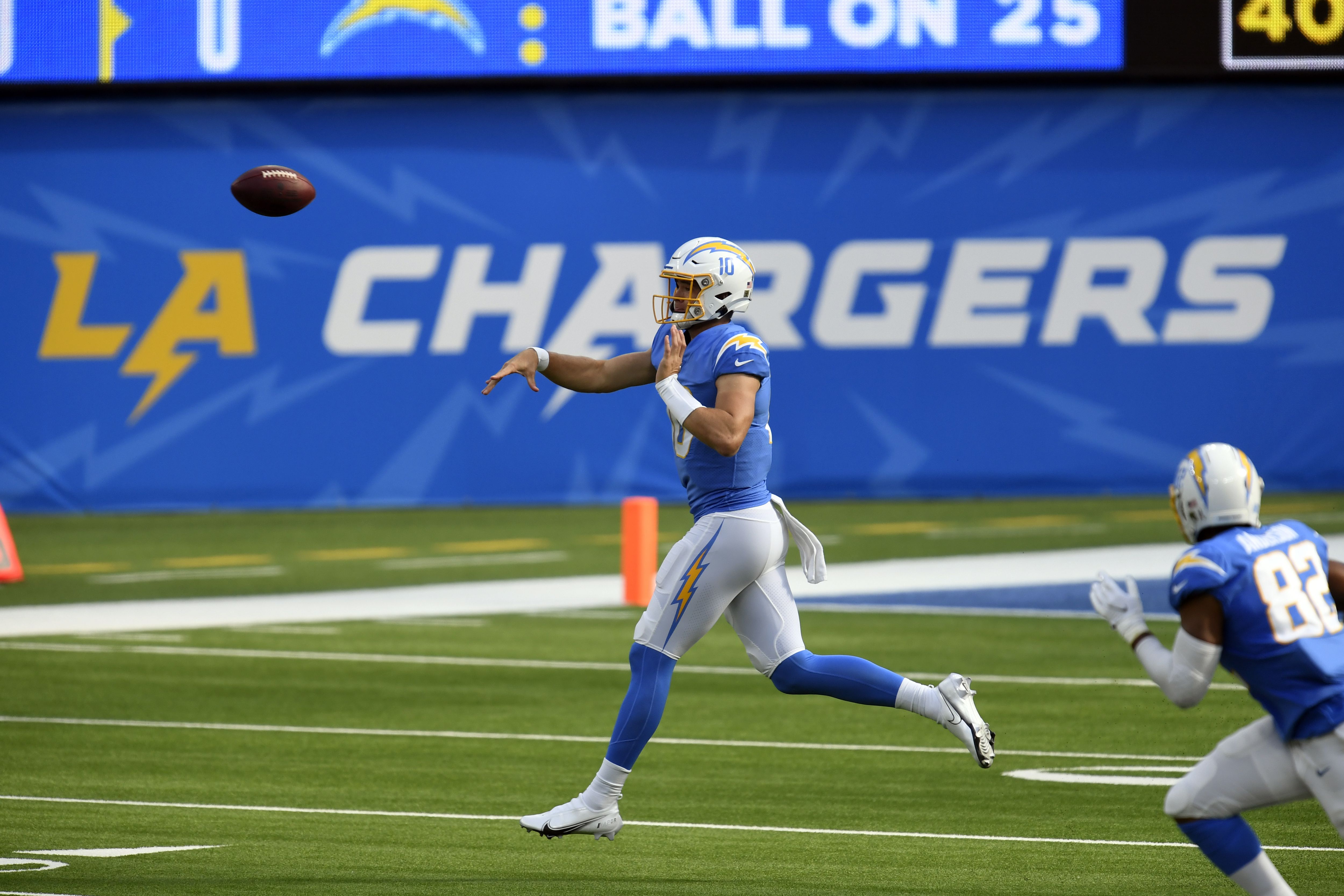 Los Angeles Chargers Justin Herbert Unsigned Gold Pants Throwing Pass  Vertical Photograph