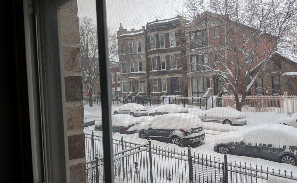 Vehicles covered in snow are seen in Chicago