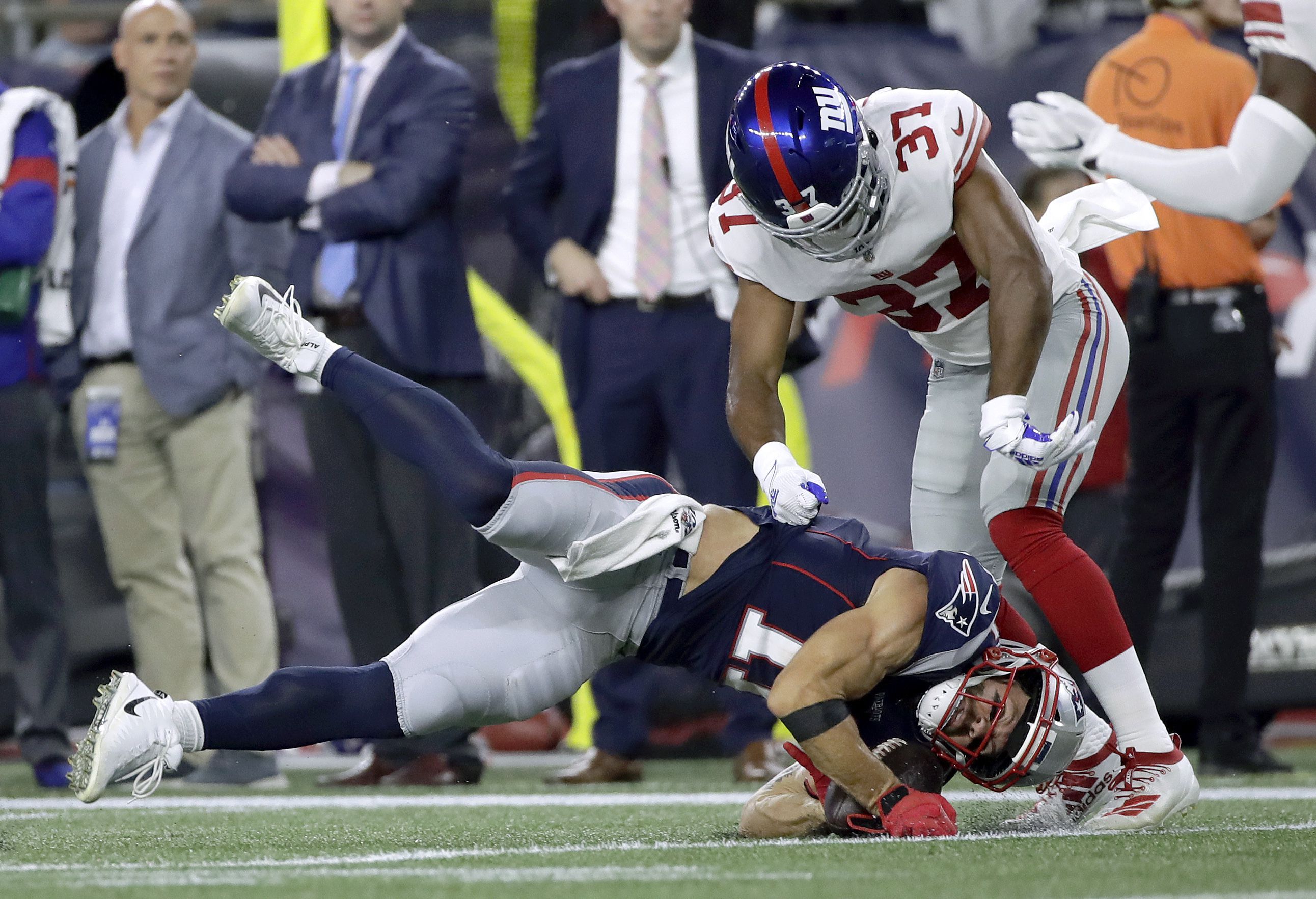 New York Giants cornerback Julian Love (37) tackles New England Patriots  wide receiver Julian Edelman in the first half of an NFL preseason football  game, Thursday, Aug. 29, 2019, in Foxborough, Mass. (