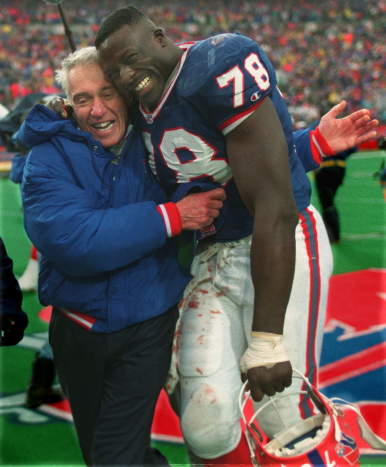 Buffalo Bills linebacker Cornelius Bennett, right, helps Houston Oilers  quarterback Warren Moon to his feet after sacking him in the third quarter  of their AFC playoff game at Rich Stadium in Orchard