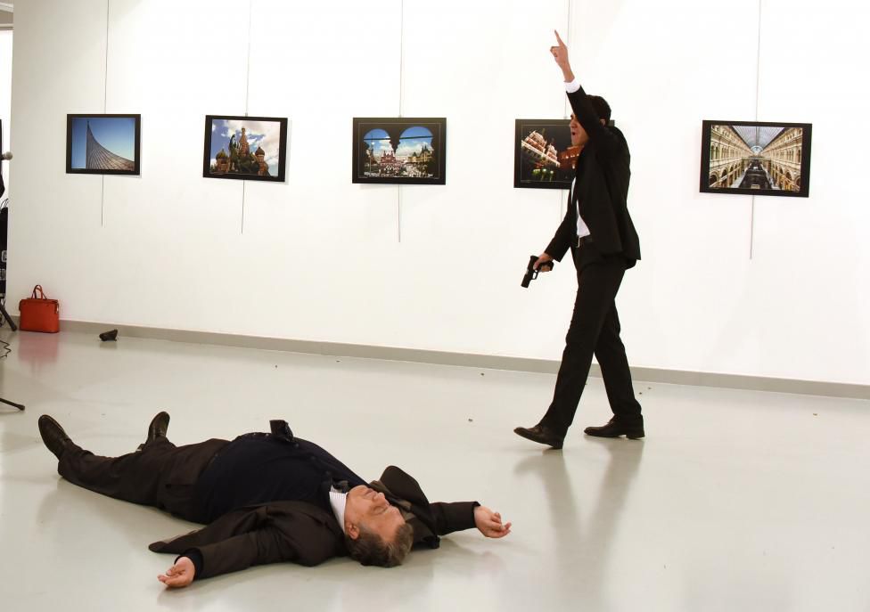 Russian Ambassador to Turkey Karlov lies on the ground after he was shot by unidentified man at an art gallery in Ankara