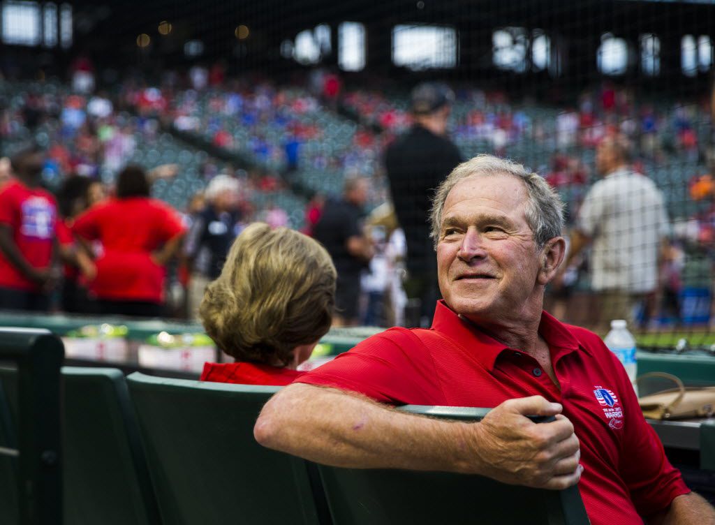 Former President George W. Bush, talks with Texas Rangers CEO