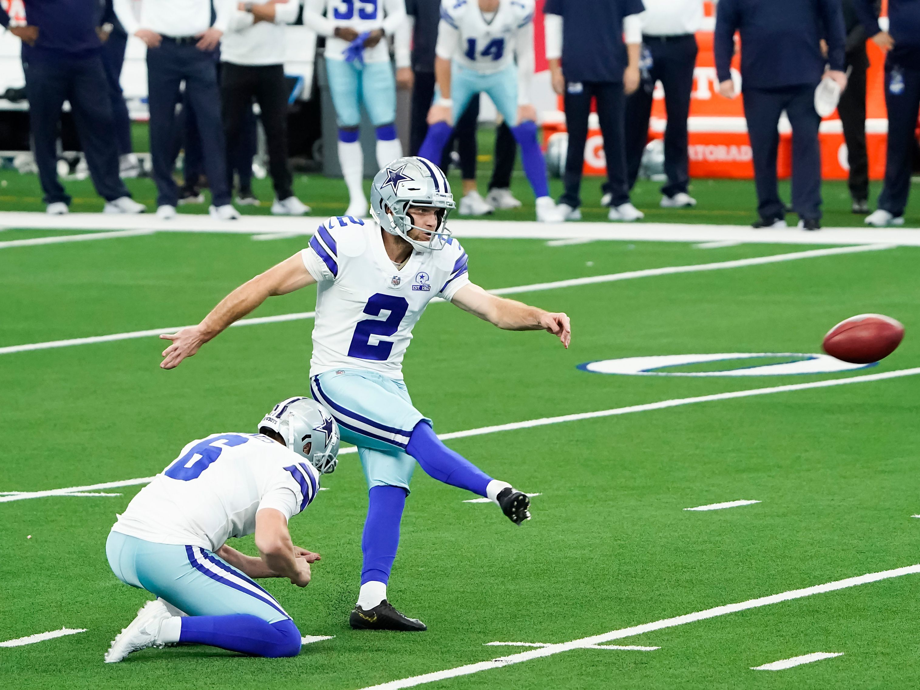 Dallas Cowboys' and Denver Broncos' kickers and other special-teams  players warm up prior to a National Football League game at the Cowboys'  home field AT&T Stadium in Arlington, Texas