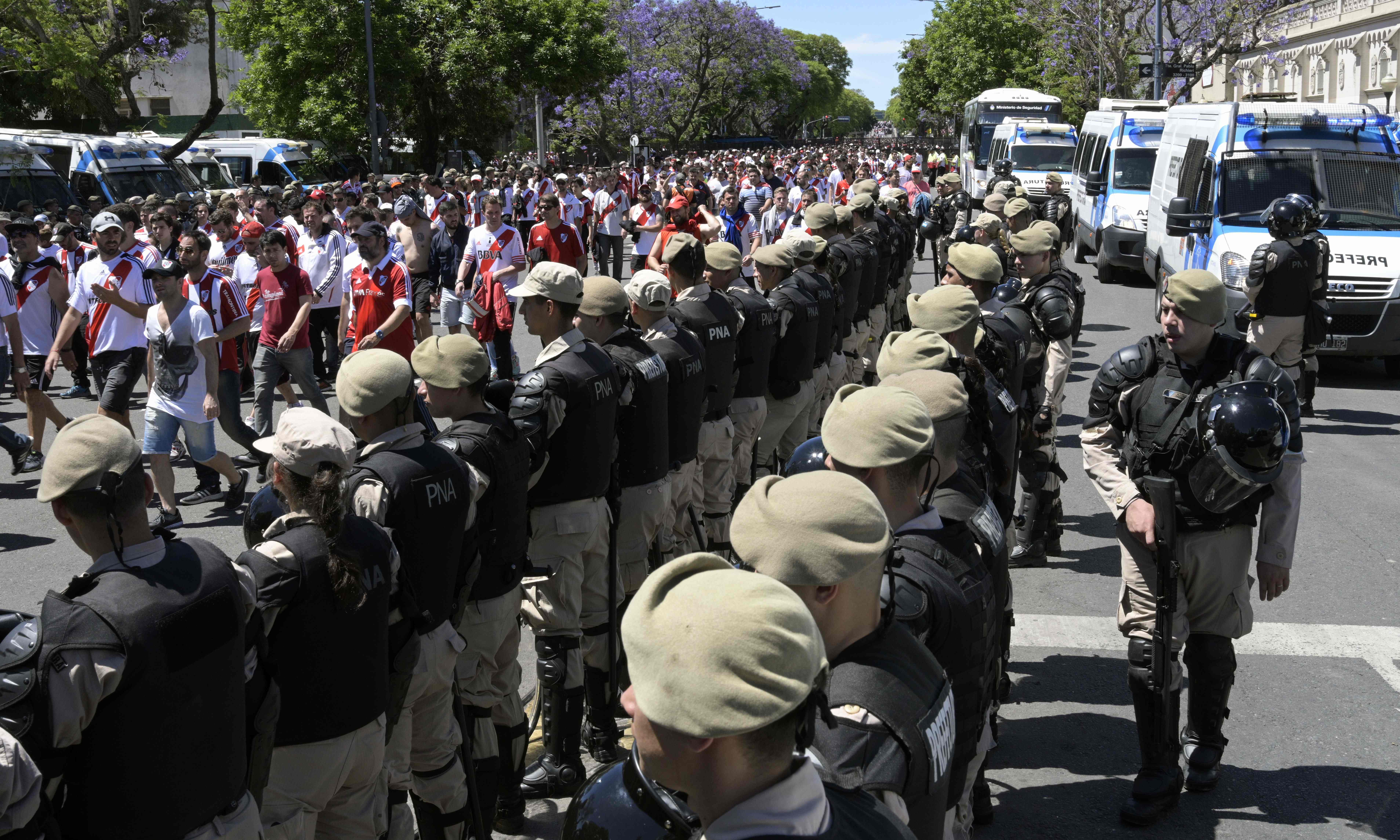 Security forces stand guard as River Plate's supporters leave the Mon