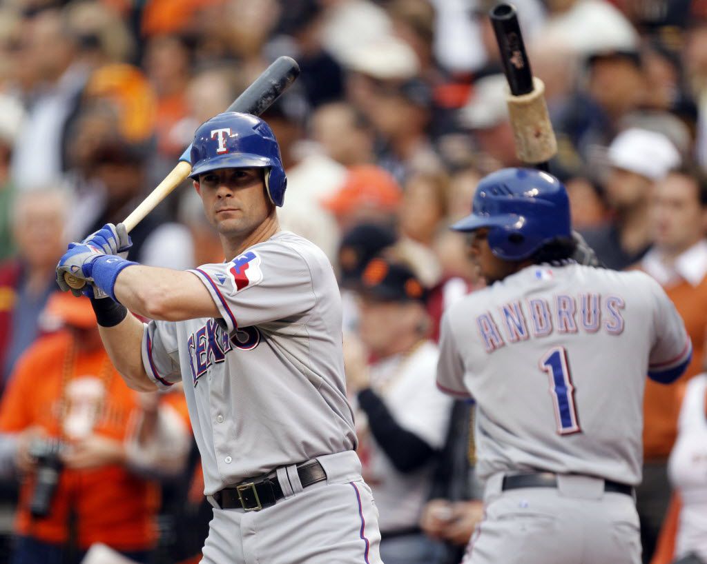 Texas Rangers Elvis Andrus slaps hands with the bat boy after