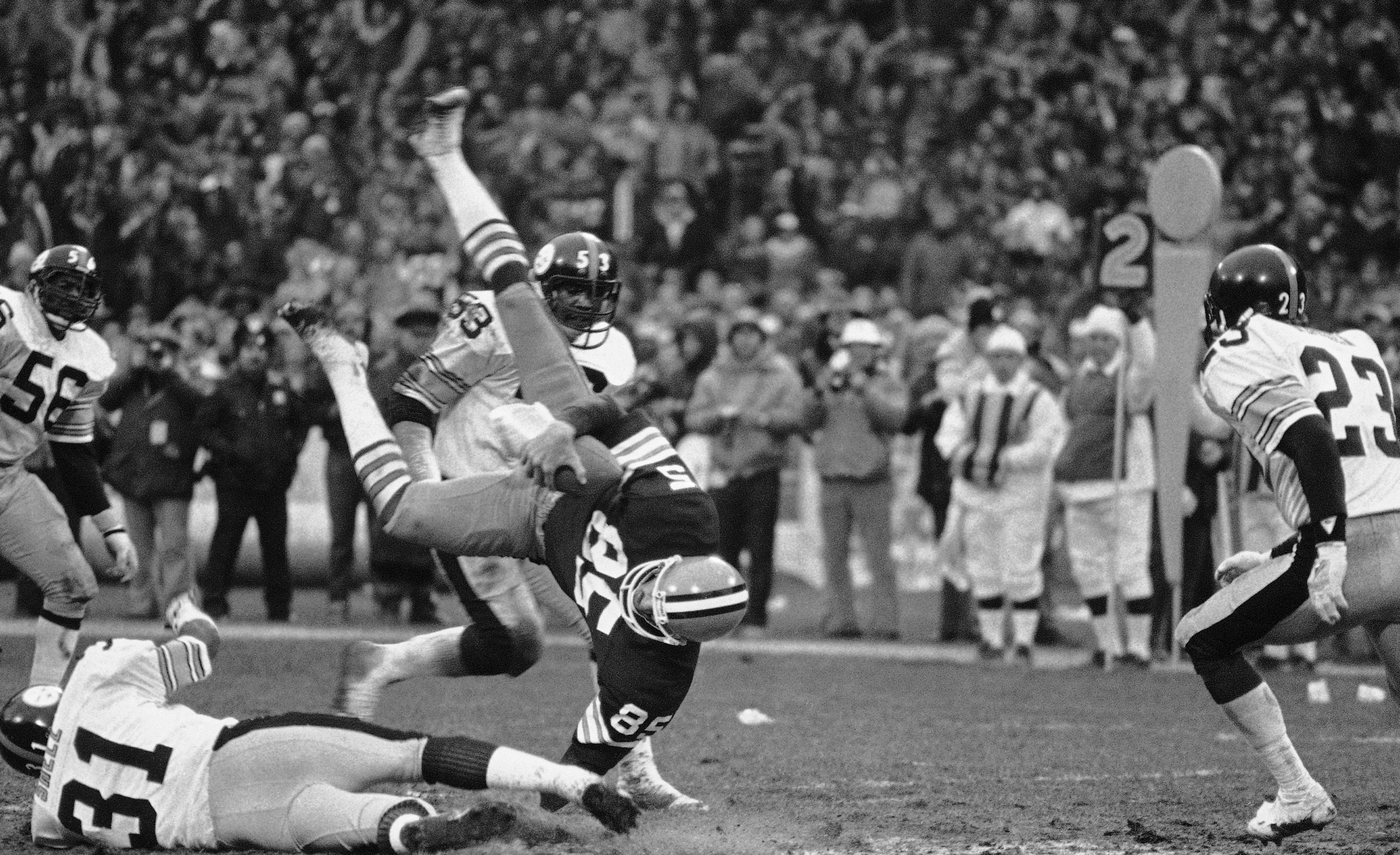 Cleveland Browns quarterback Brian Sipe takes a break during a snowfall at  a late season game at Cleveland Stadium in December, 1980. The Browns,  known then as the Karciac Kids, won the