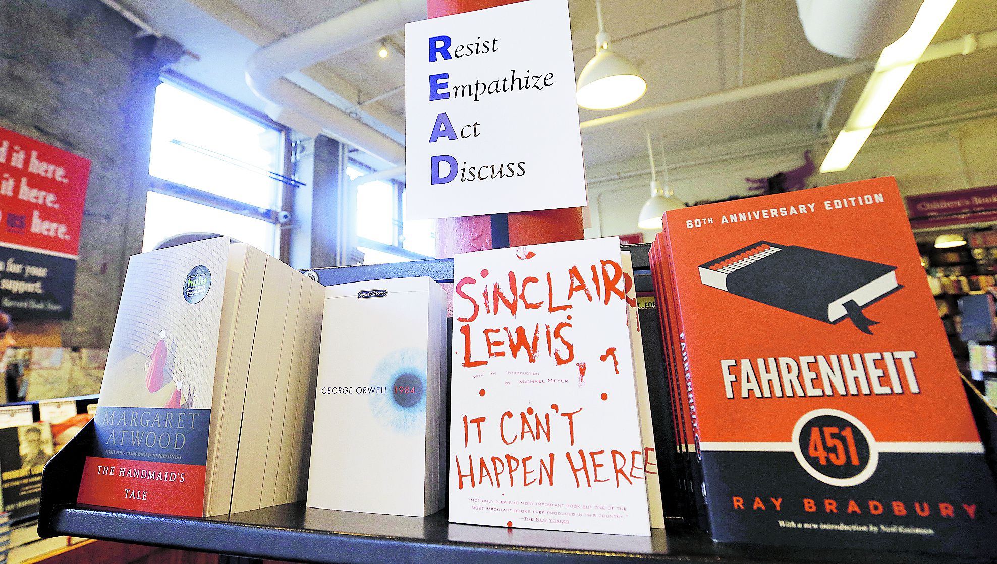 Books are displayed under a sign at the Harvard Book Store