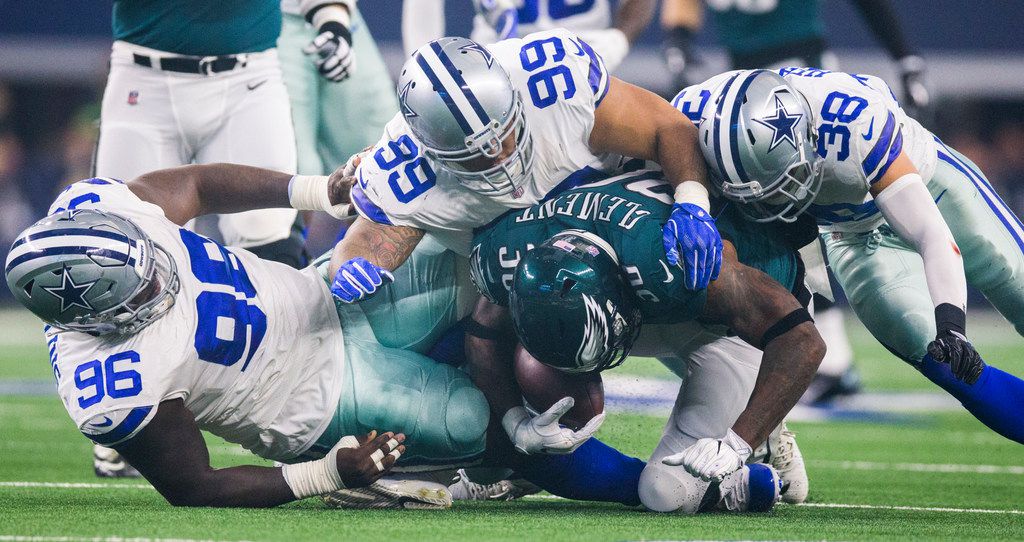 Dallas Cowboys running back Corey Clement (32) wears a Salute to Service  towel and decals on his helmet during warm ups before an NFL football game  against the Denver Broncos, Sunday, Nov.