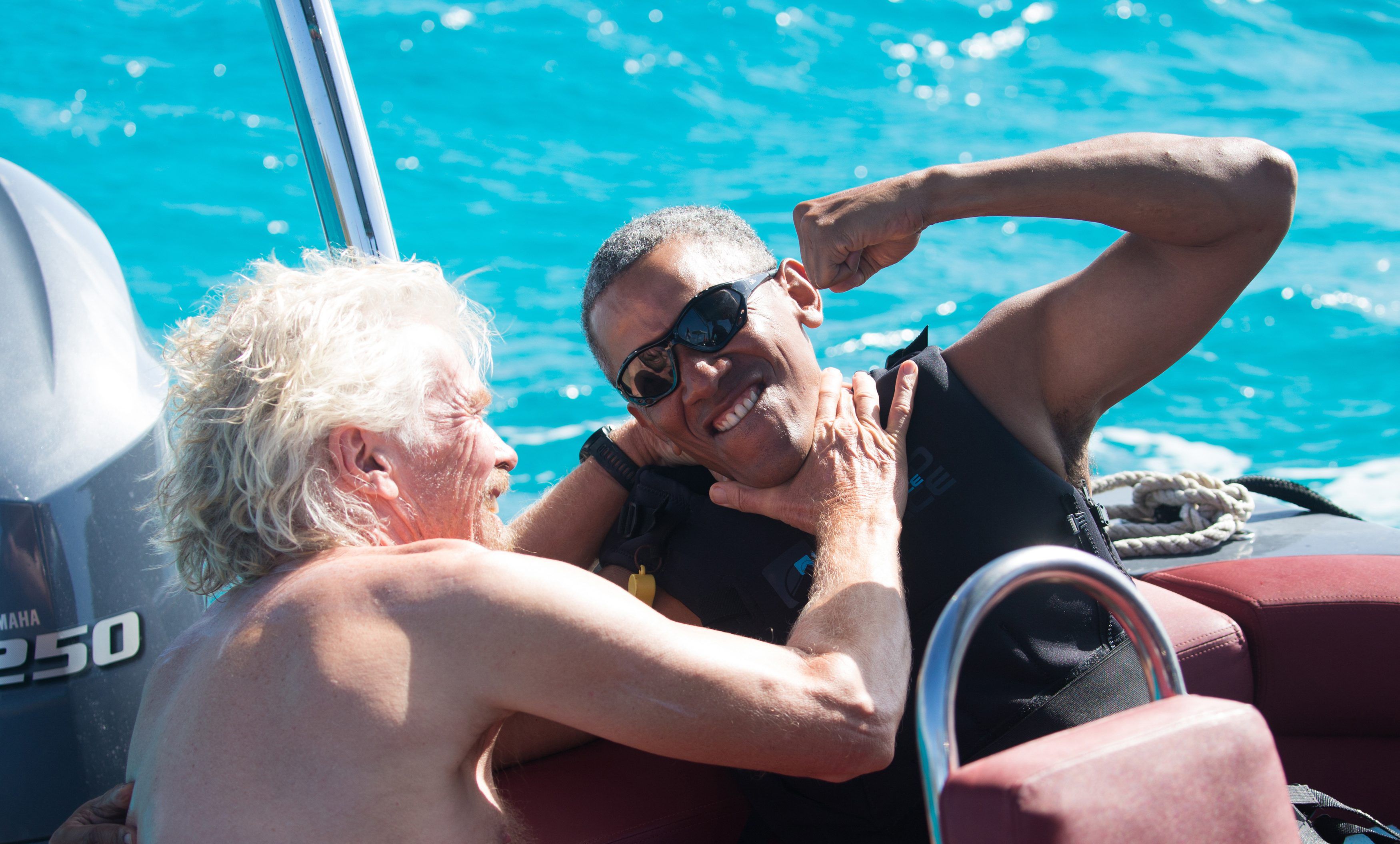 Former U.S. President Barack Obama and British businessman Richard Branson sit on a boat during Obama's holiday on Branson's Moskito island, in the British Virgin Islands, in a picture handed out by Virgin