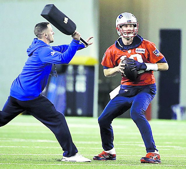 New England Patriots quarterback Tom Brady looks to pass during NFL f