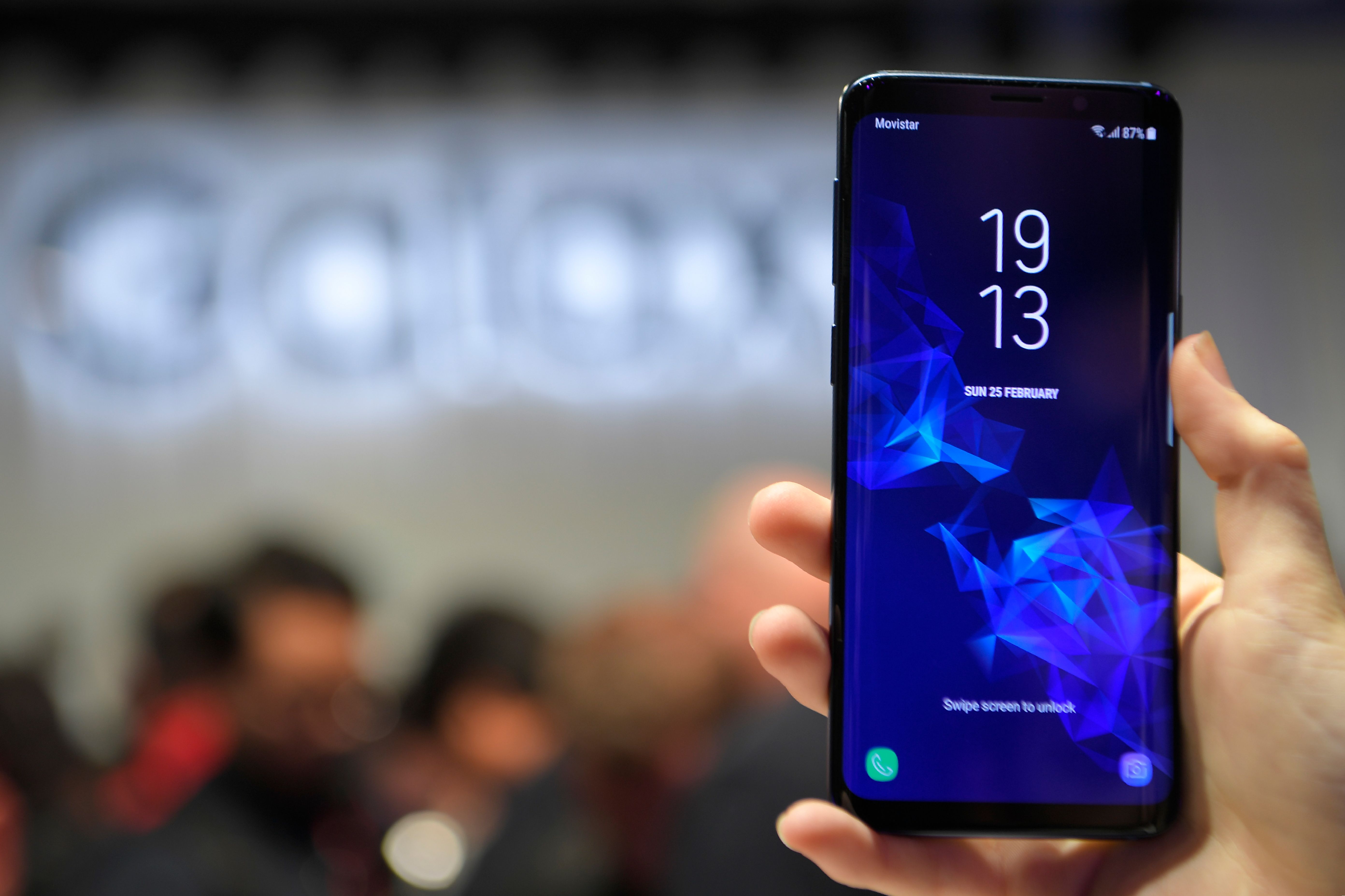 A woman holds a new Samsung Galaxy S9 mobilephone during the Samsung