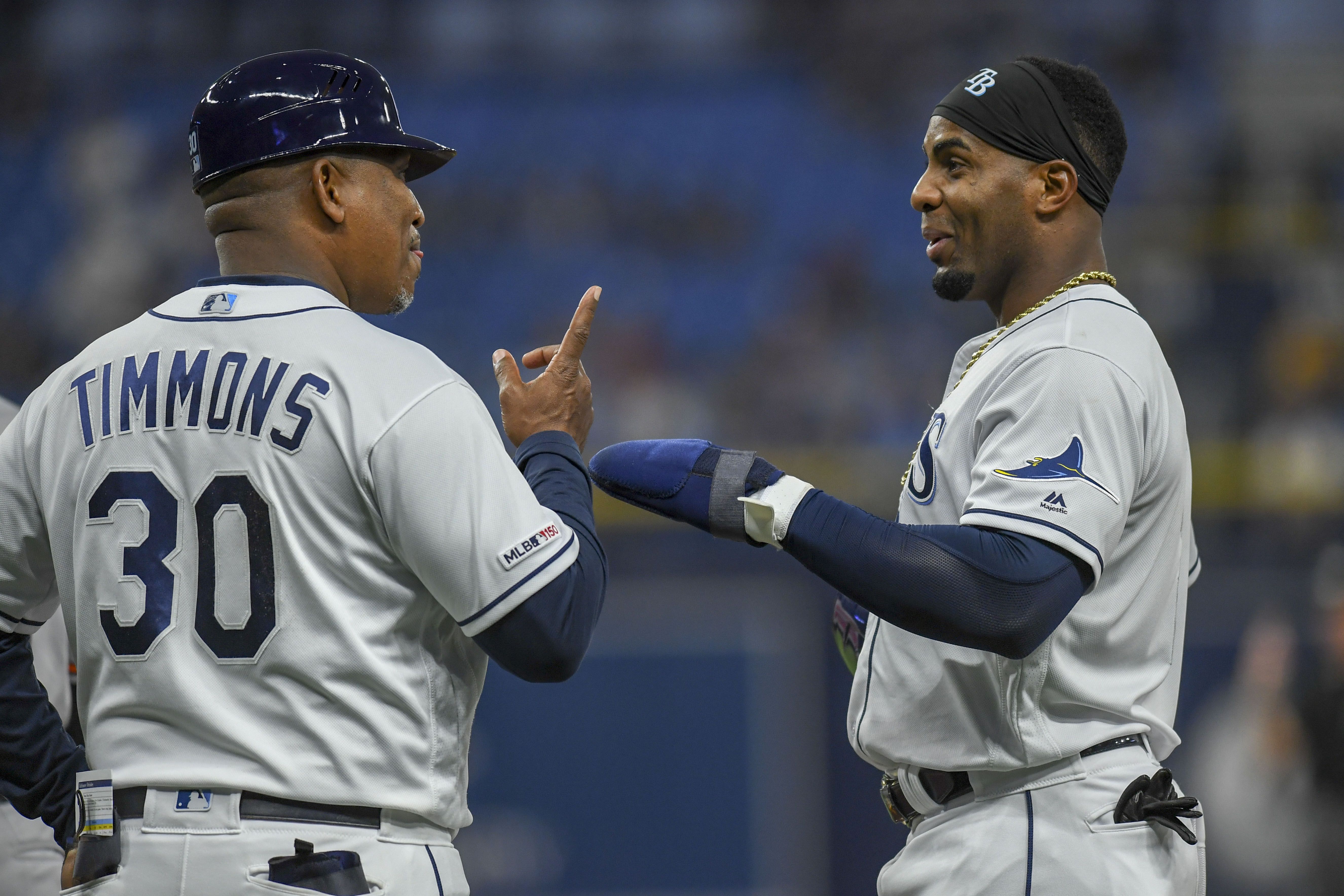 Tampa Bay Rays first base coach George Hendrick, left, talks with