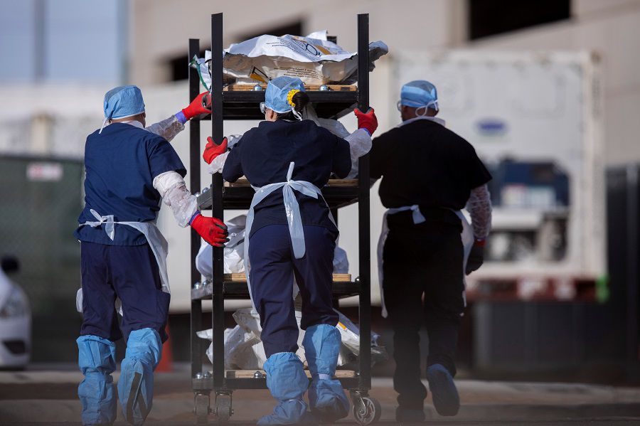 El Paso County Medical Examiner's Office staff move bodies in El Paso