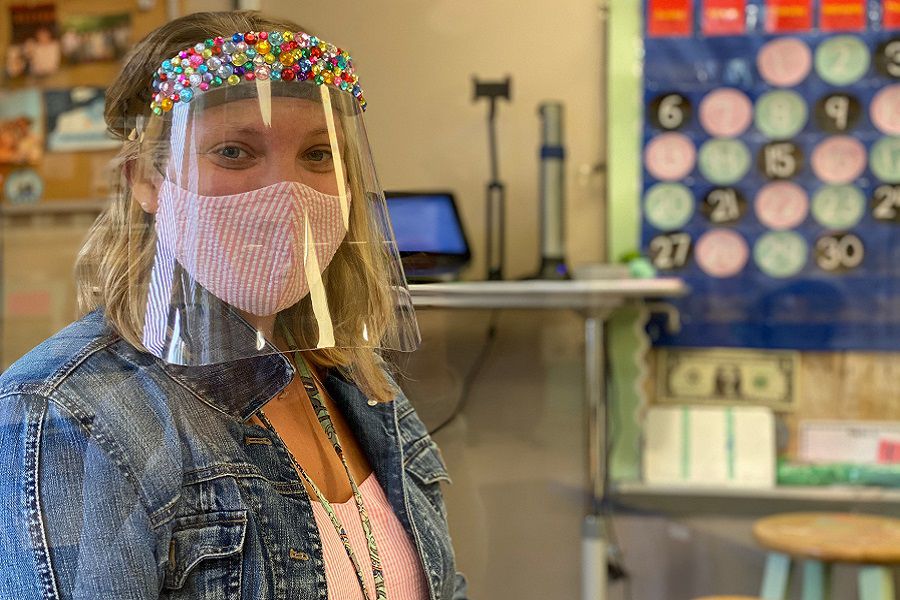 Mindy Bassett, a first grade teacher at Union Memorial School, a K-2 elementary in Colchester, shows off her bedazzled face