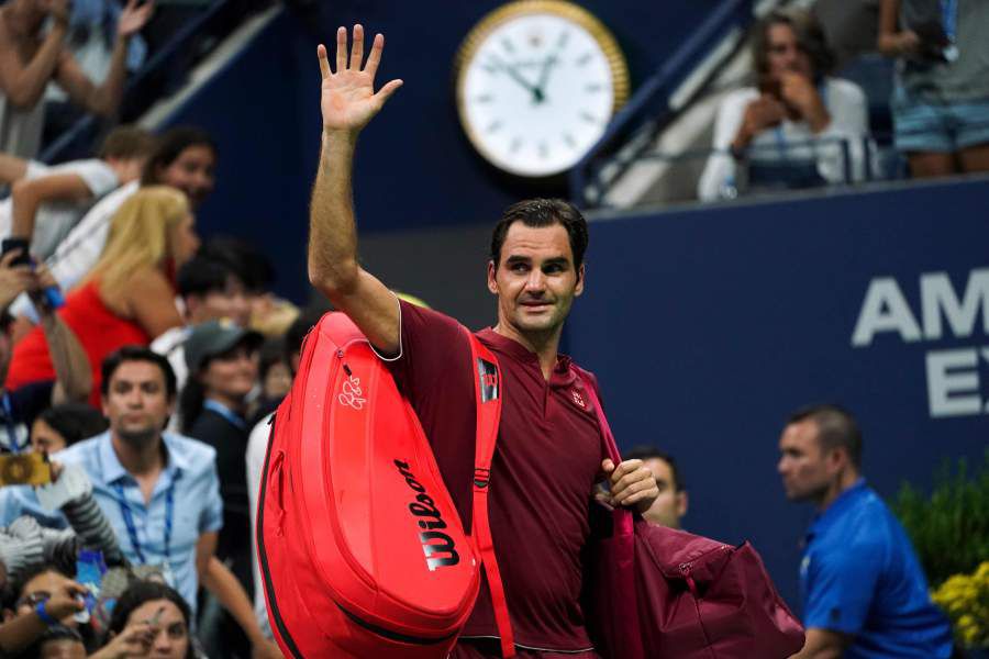 Switzerland's Roger Federer waves as he walks off court after losing