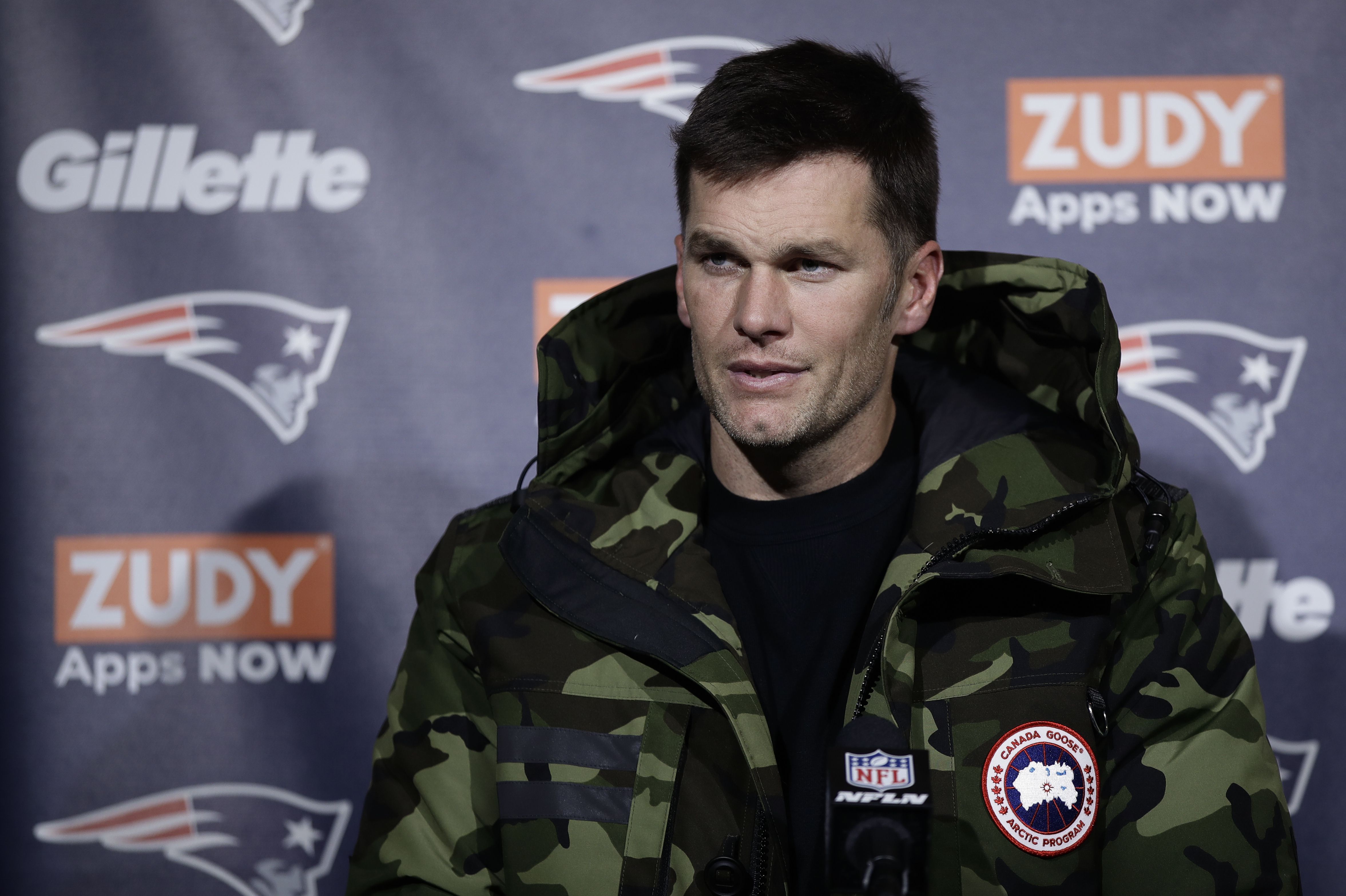 New England Patriots quarterback Tom Brady sits dejectedly near