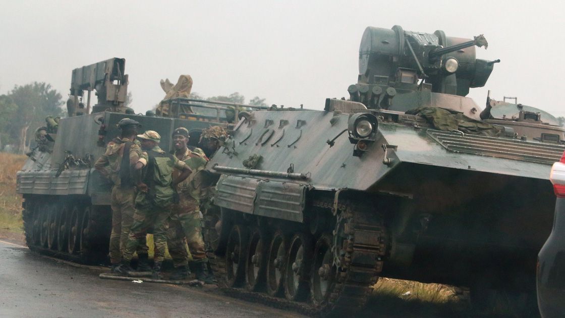 Soldiers stand beside military vehicles just outside Harare, Zimbabwe