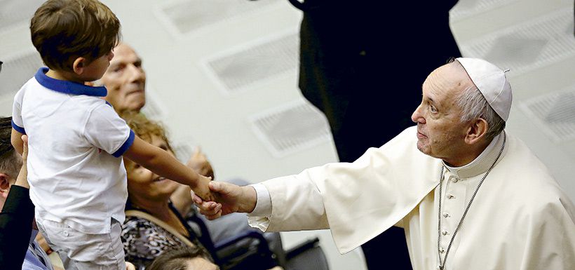 pope-francis-shakes-hands-with-a-boy-during-38835501