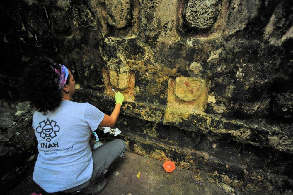 An archeologist works cleaning the stucco of the Temple of the U, located in the archaelogy area of Kuluba, in Tizimin