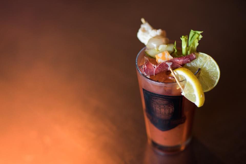 Bloody Mary Cocktail in glasses with garnishes. Stock Photo by nblxer