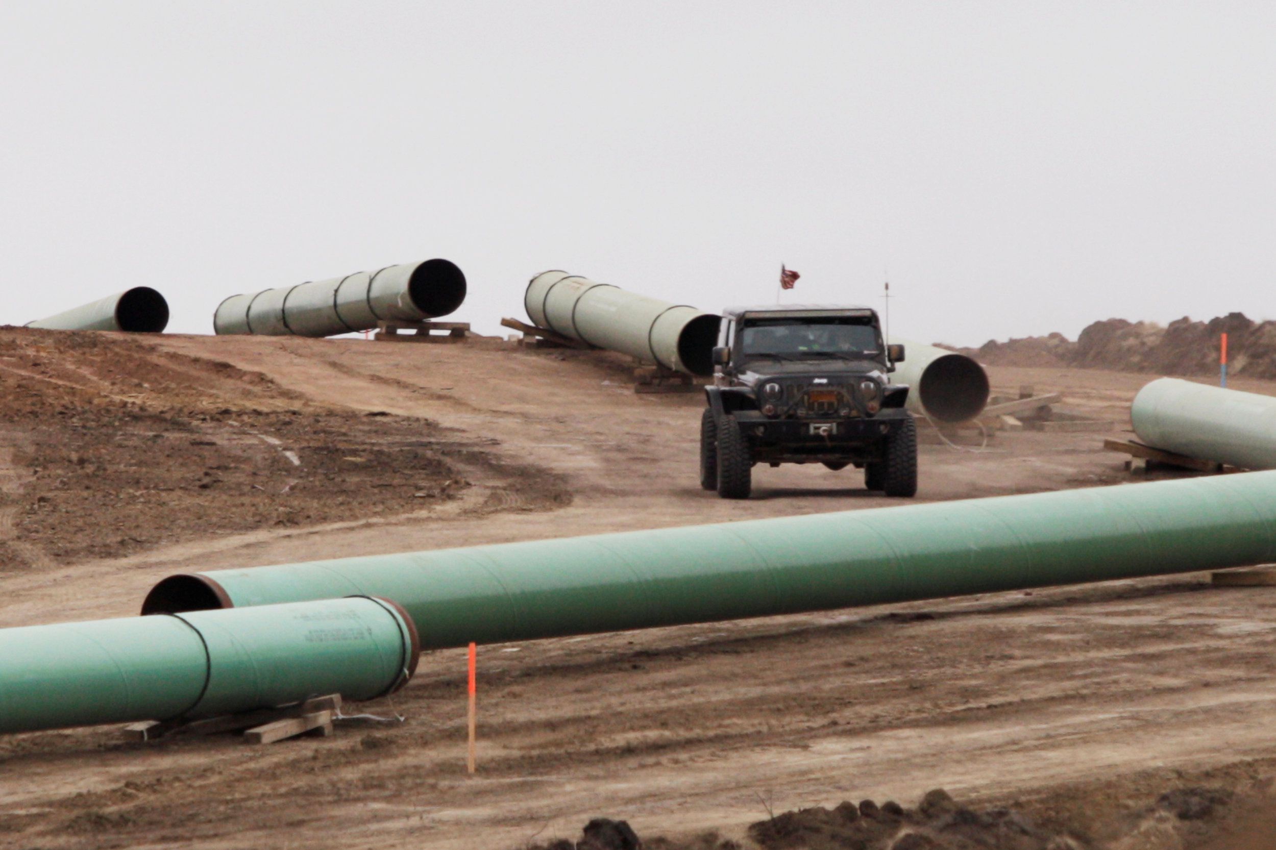 File photo of a vehicle driving next to a series of pipes at a Dakota Access Construction site near the town of Cannon Ball