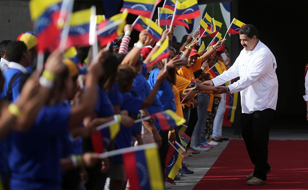 Venezuela's President Nicolas Maduro greets supporters as he arrives for an event with women at Miraflores Palace in Caracas