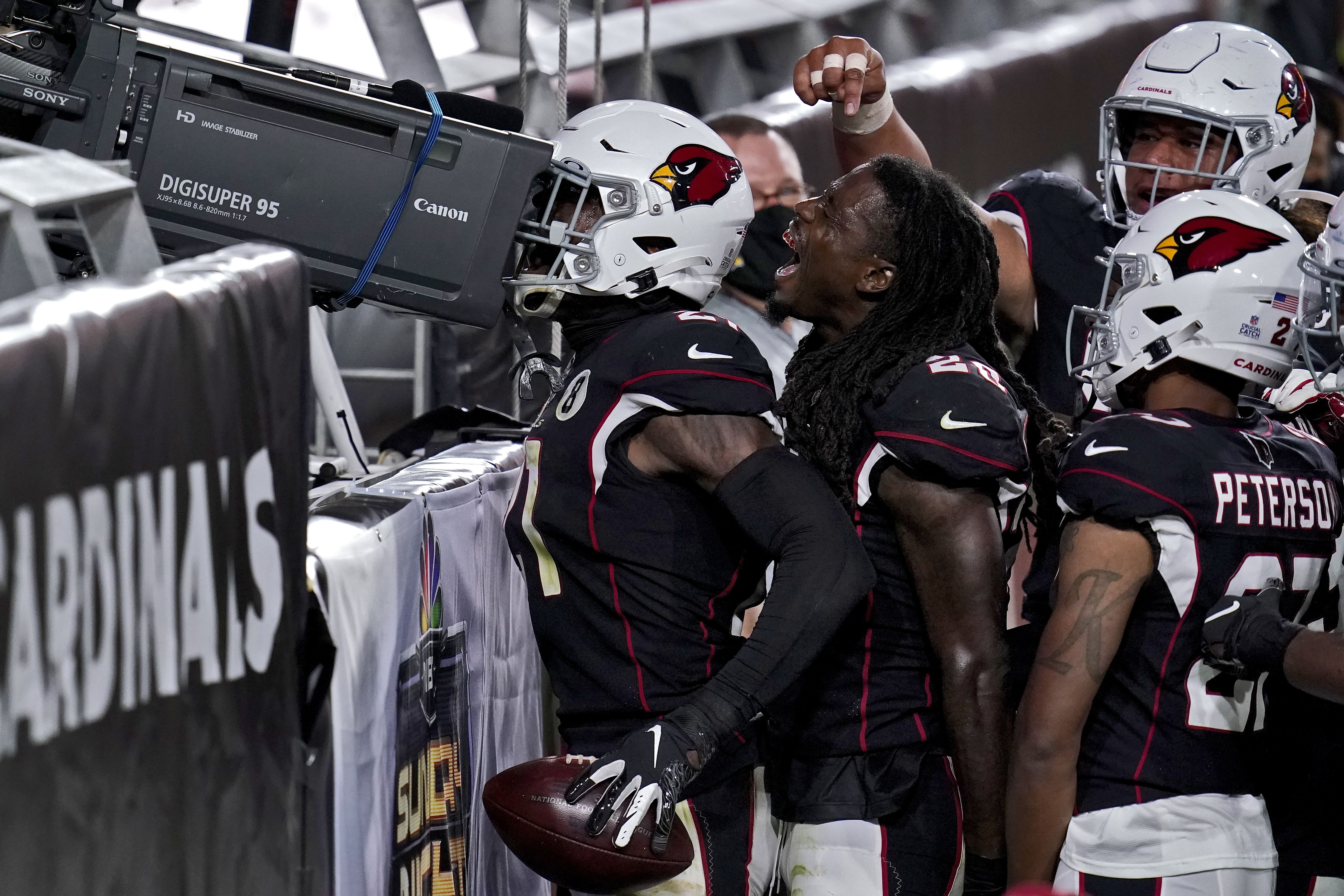 Seattle Seahawks guard Damien Lewis, left, celebrates with head coach Pete  Carroll after the team scored during the first half of an NFL football game  against the Arizona Cardinals in Glendale, Ariz.