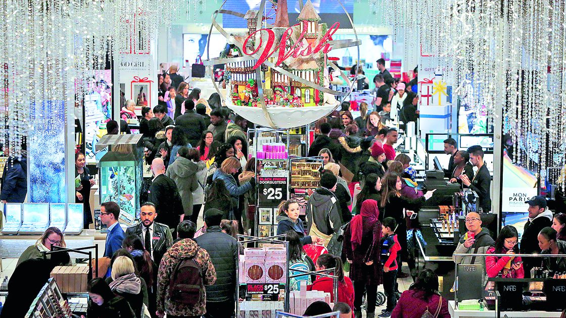 FILE PHOTO: People shop in Macy's Herald Square during early opening for the Black Friday sales in Manhattan