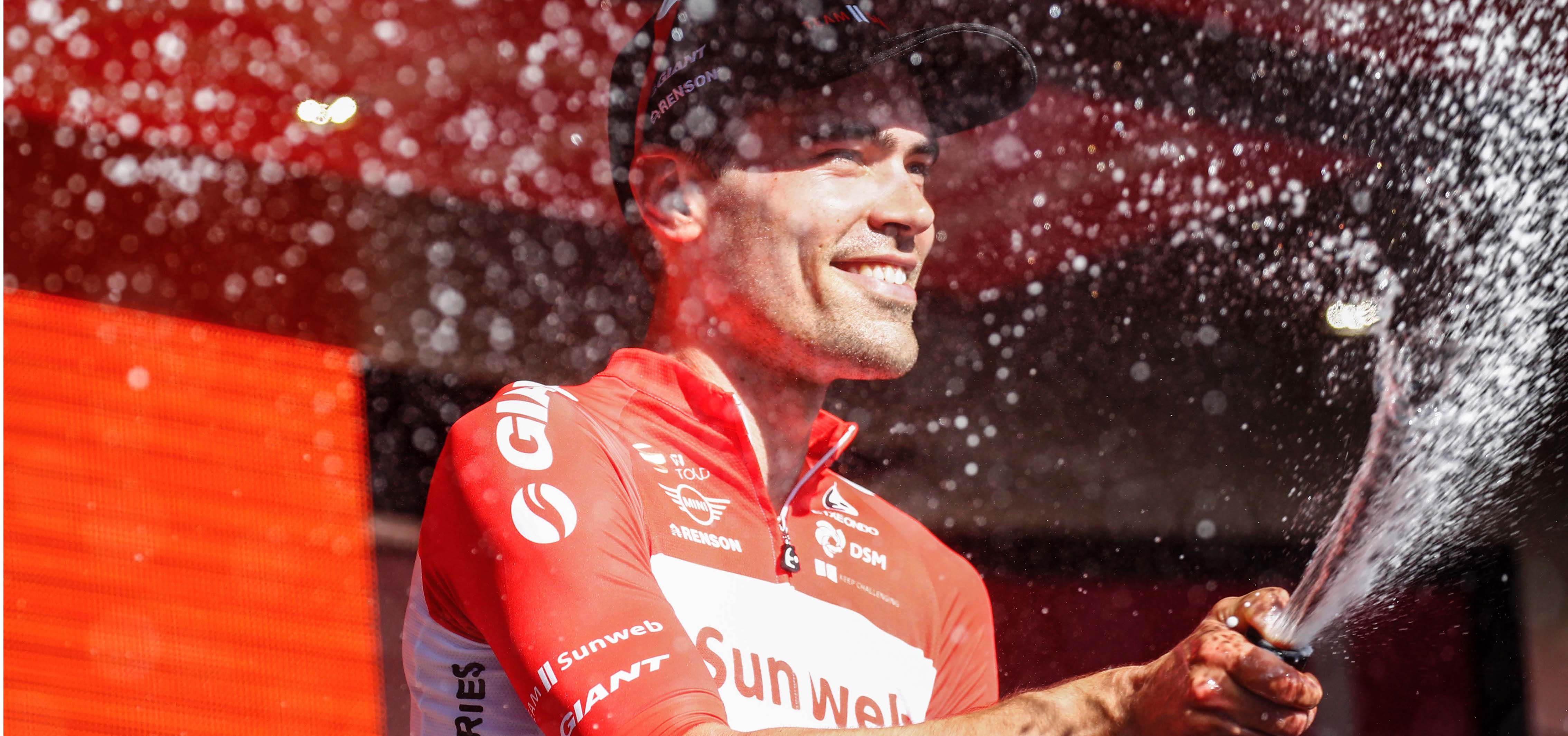 Dutch cyclist Tom Dumoulin from Team Sunweb sprays champagne as he ce