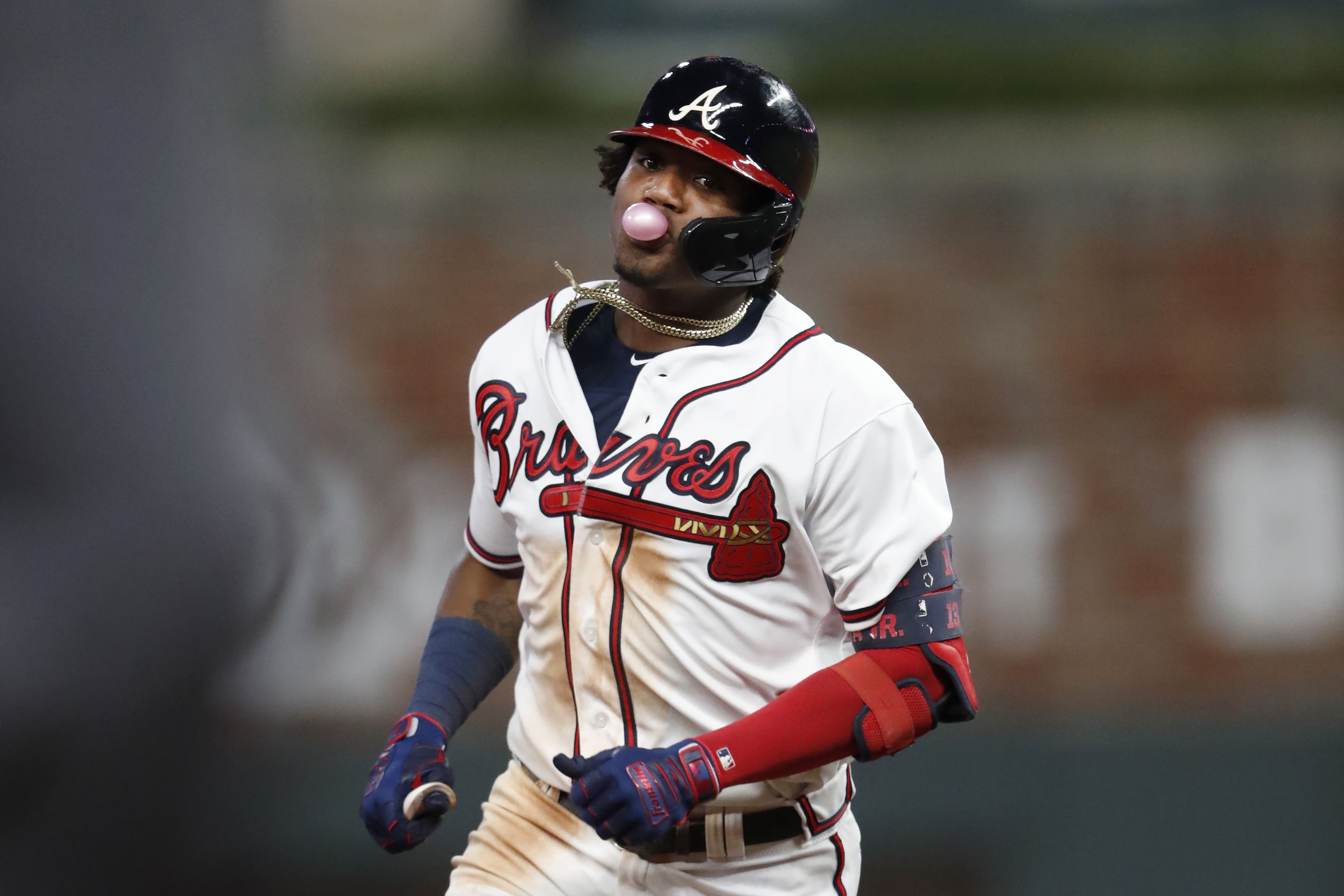 Atlanta Braves' Ronald Acuna Jr. (13) blows a bubble after he hit