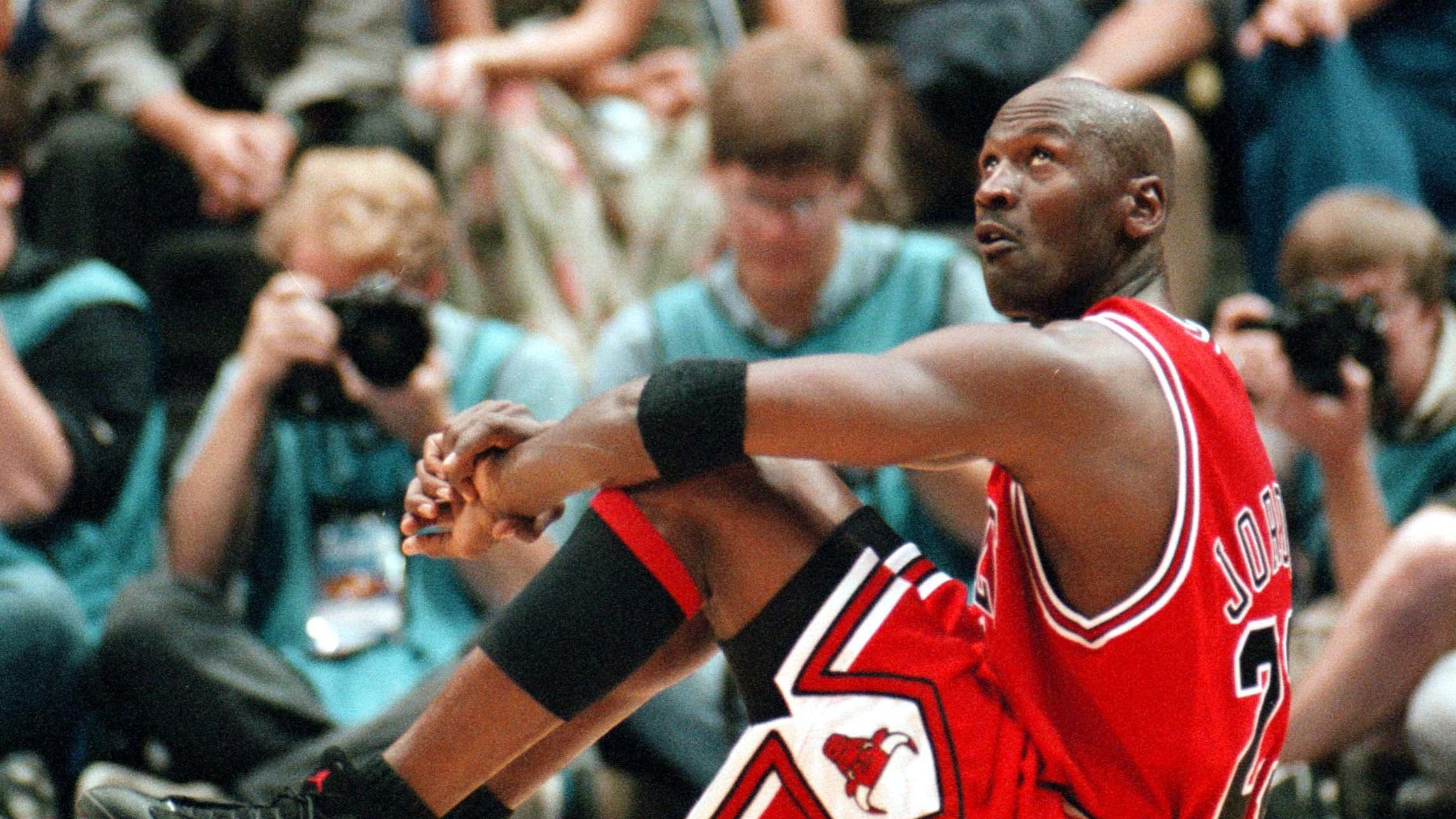 Jud Buechler and Michael Jordan of the Chicago Bulls high five