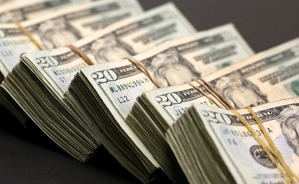 FILE PHOTO:Bundles of banknotes of U.S. Dollar are pictured at a currency exchange shop