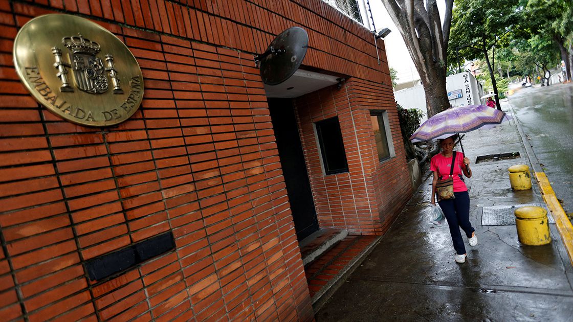 FILE PHOTO: A pedestrian passes next to the Spanish embassy in Caracas