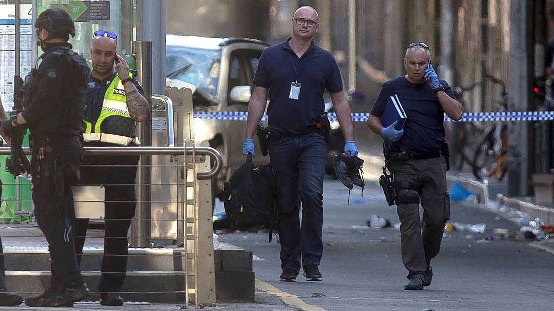 Australian police is seen near the place where they arrested the driver of a vehicle that had ploughed into pedestrians at a crowded intersection near the Flinders Street train station, in central Melbourne