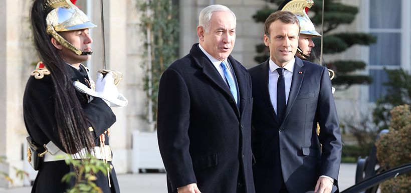 French President Emmanuel Macron (R) welcomes Israeli Prime Minister