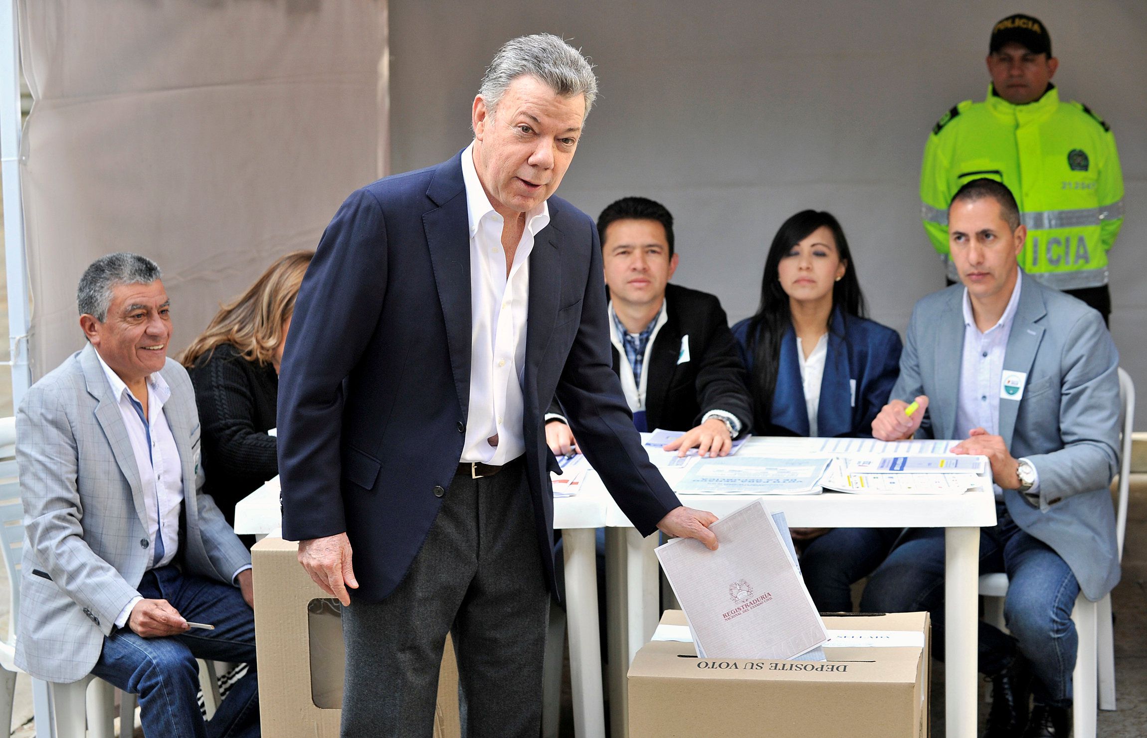 Colombia's President Juan Manuel Santos casts his vote during the legislative elections in Bogota