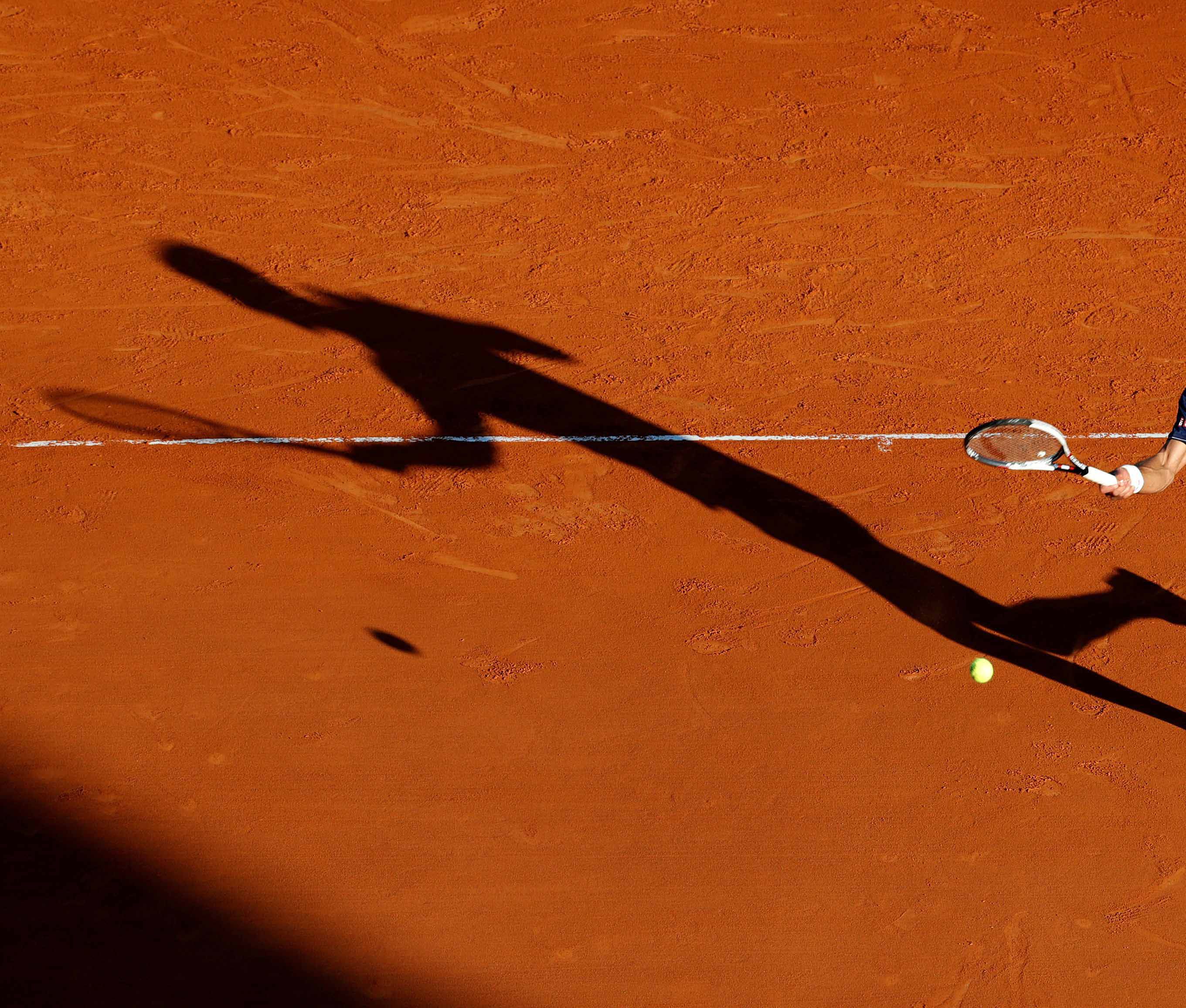 FILE PHOTO: Serbia's second seed Novak Djokovic plays a shot to Pablo Carreno Busta during his three-set victory over the Spaniard in the third round of the Monte Carlo Masters.