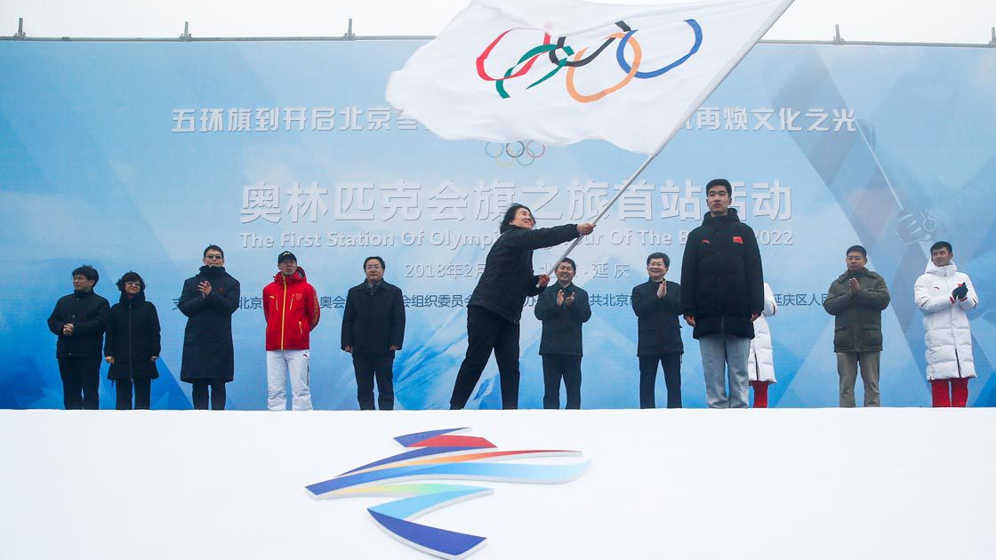 Secretary General of the Beijing Organizing Committee for the 2022 Olympic and Paralympic Winter Games Han Zirong waves the Olmypic flag during a handover ceremony in Beijing