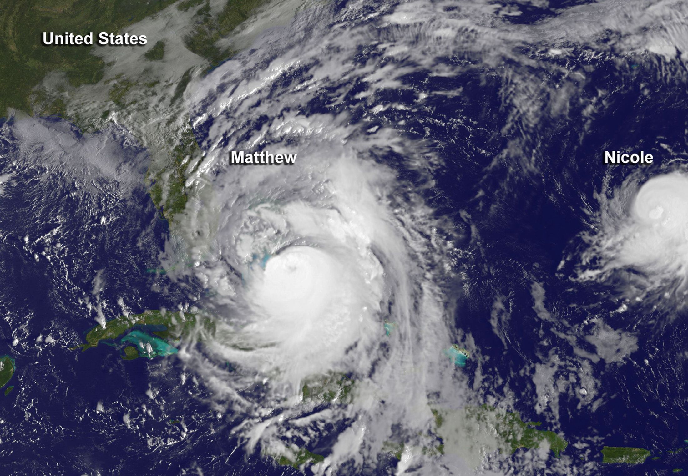 Hurricane Matthew is seen to the west of a much smaller Hurricane Nicole in this image from NOAA's GOES-East satellite