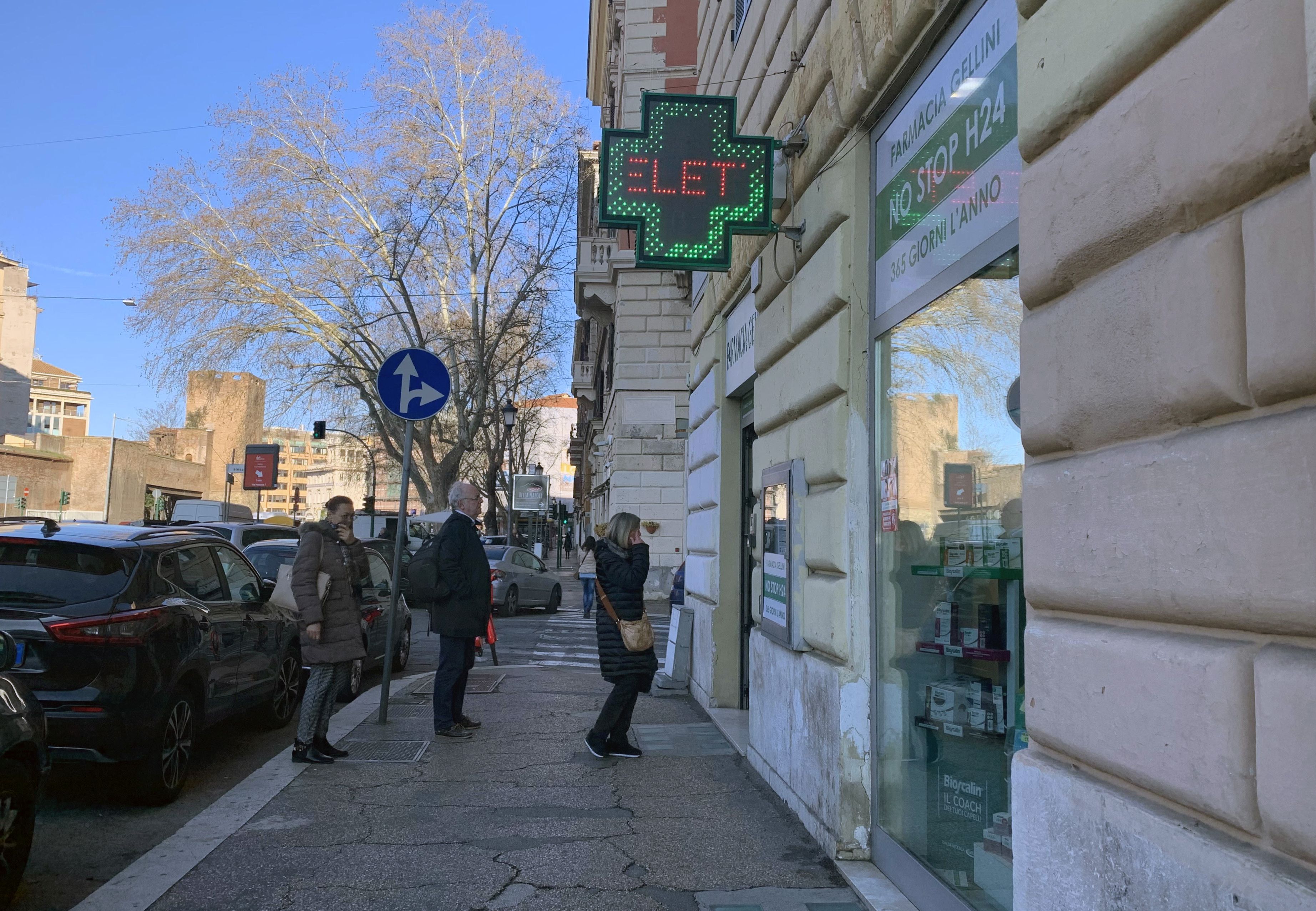 People queue up outside a pharmacy  in Rome