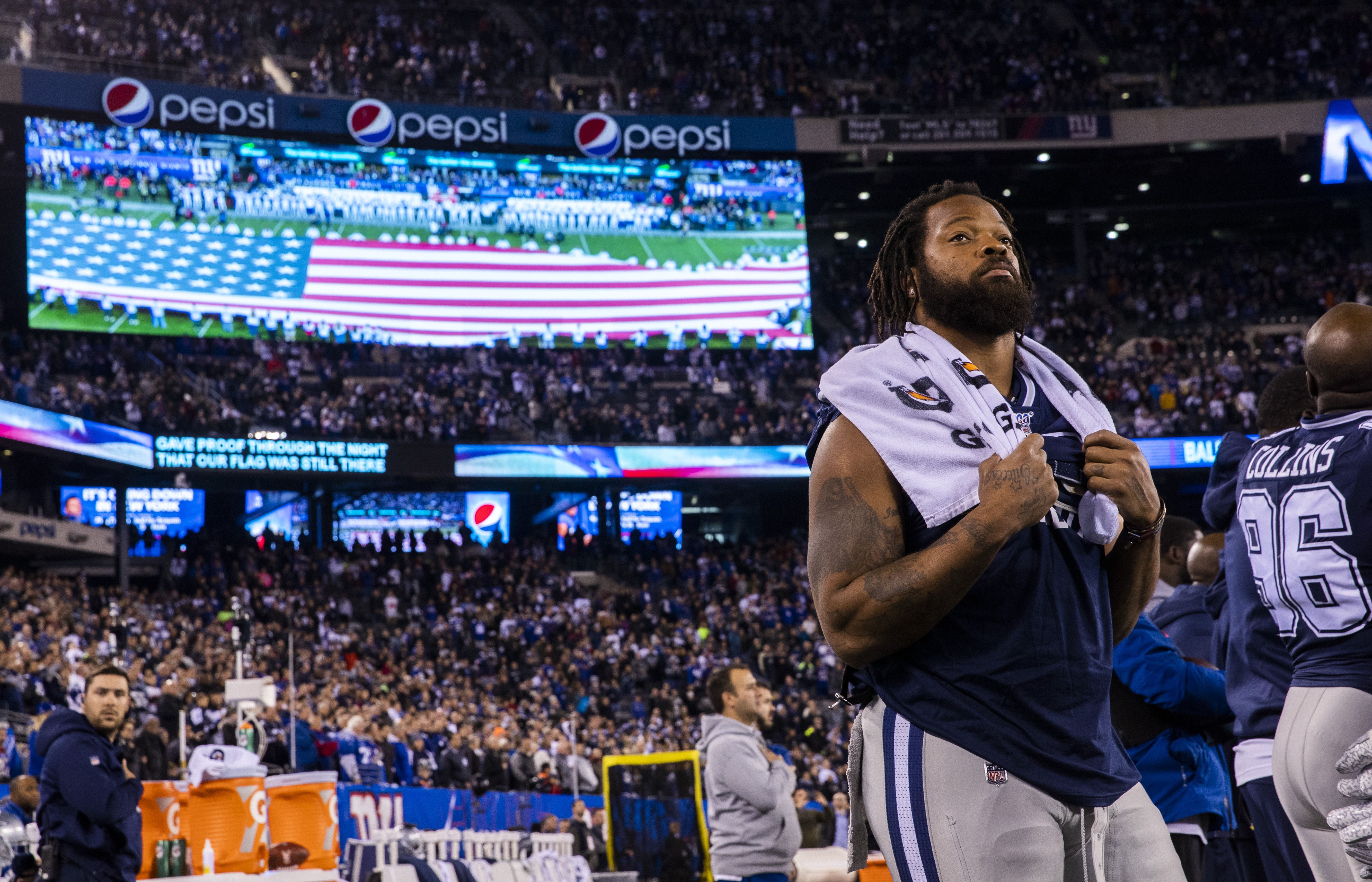 Michael Bennett, all Seahawks, stand for the national anthem on Salute to  Service night vs. Atlanta