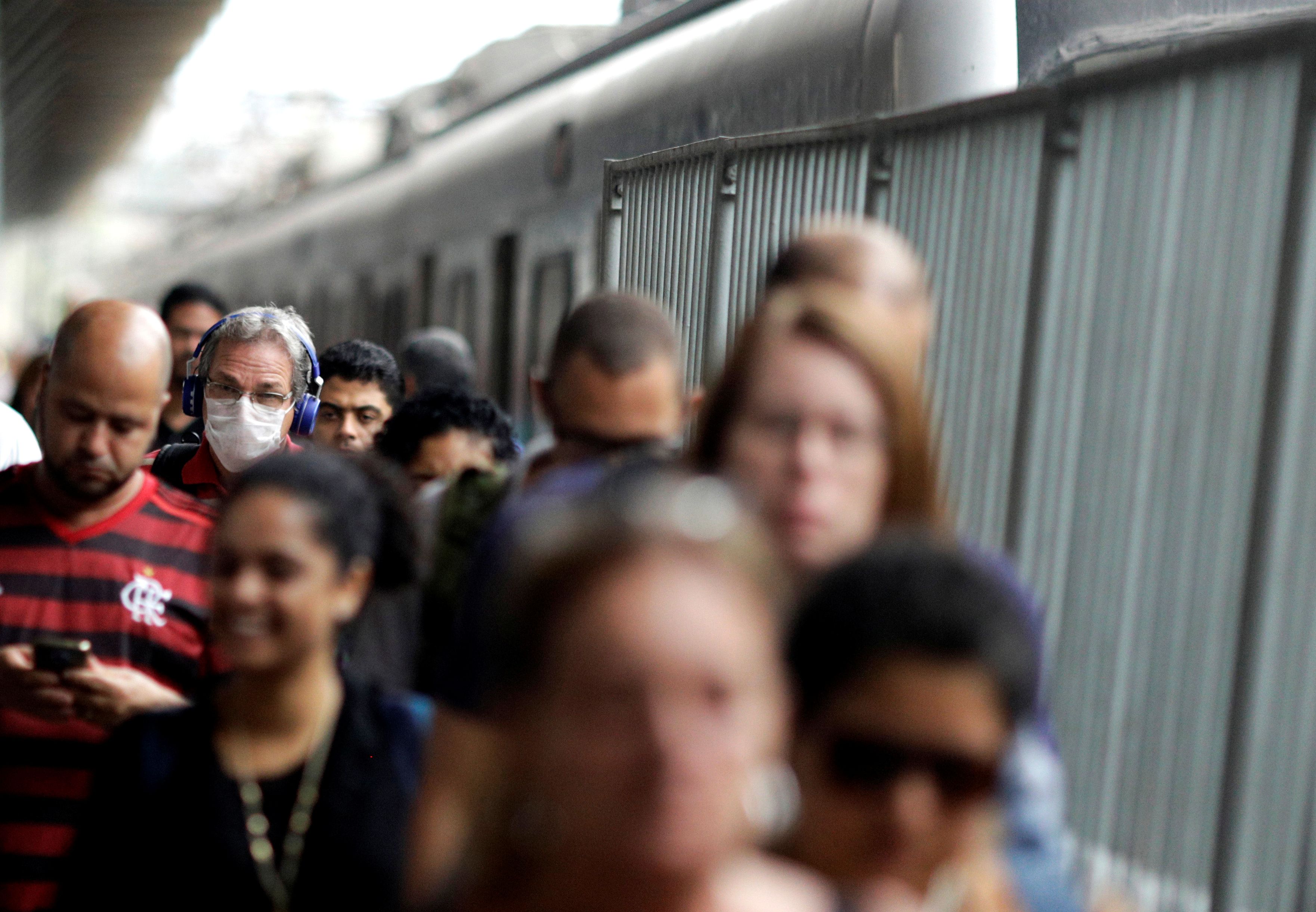 A passenger wearing a protective mask walks at Central do Brasil train station after reports of coronavirus disease (COVID-19) in Rio de Janeiro,