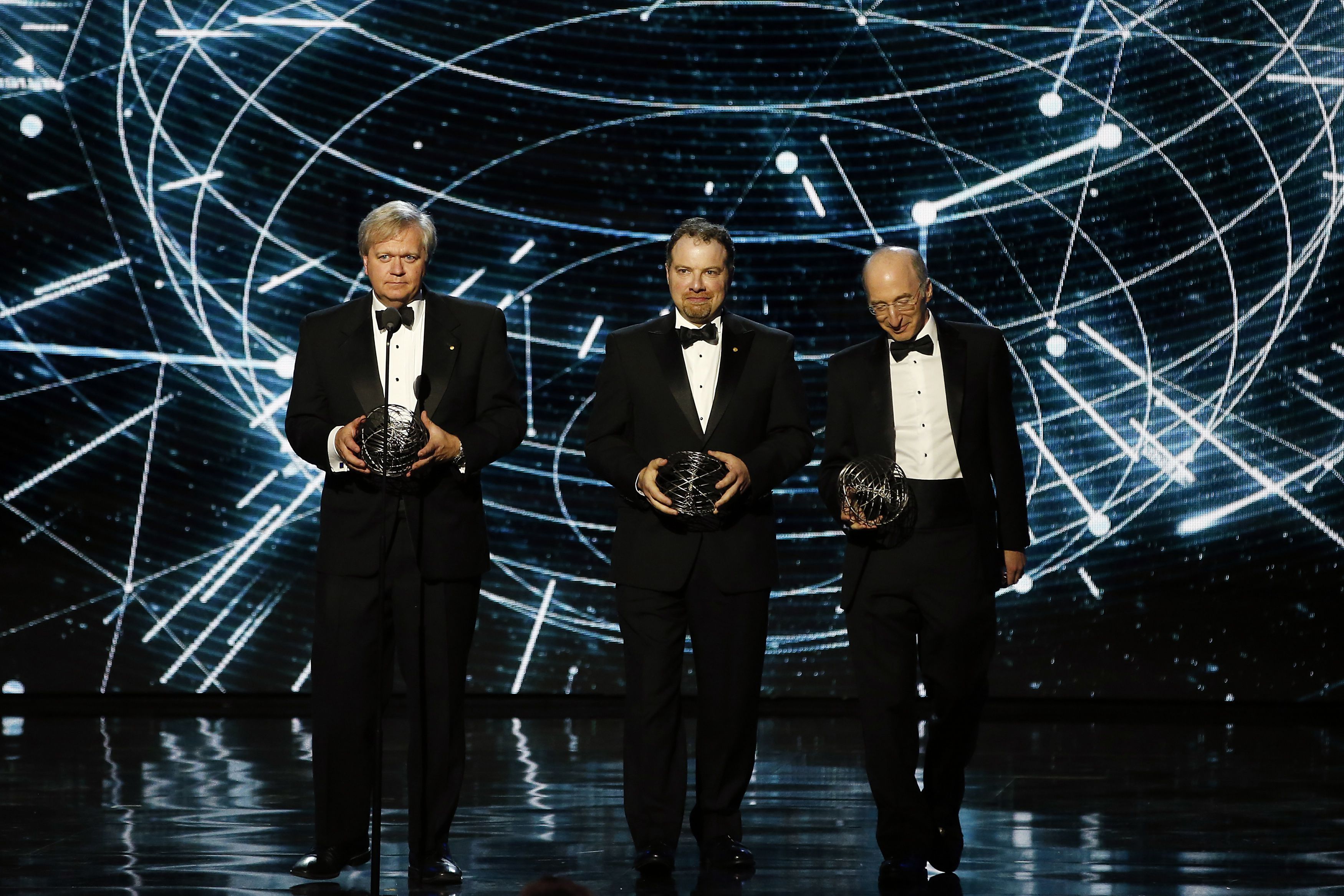 Fundamental Physics co-laureates Brian P. Schmidt, Adam G. Riess, and Saul Perlmutter speak on stage during the 2nd annual Breakthrough Prize Award in Mountain View