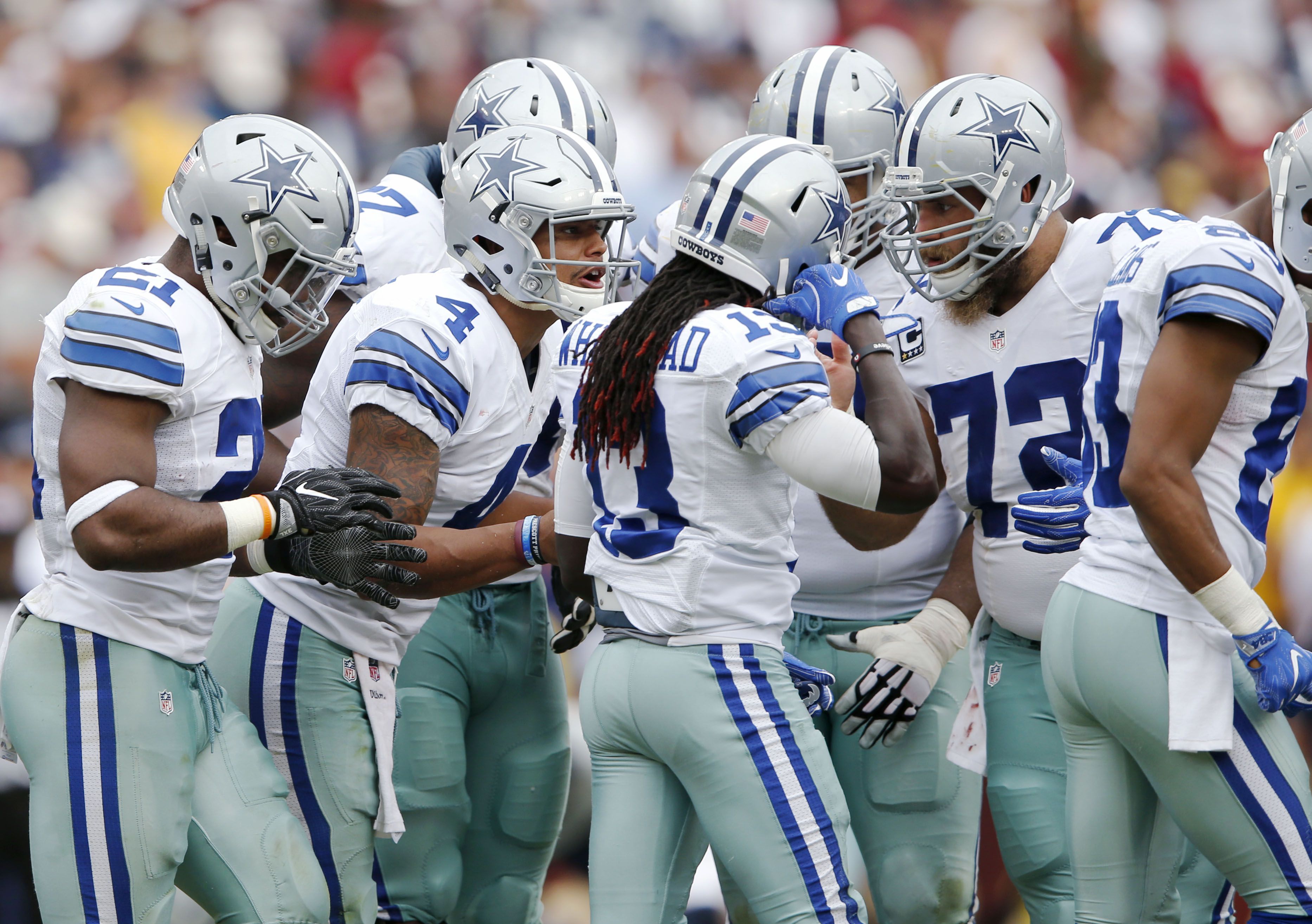 Dallas Cowboys quarterback Dak Prescott (4) in the huddle while on