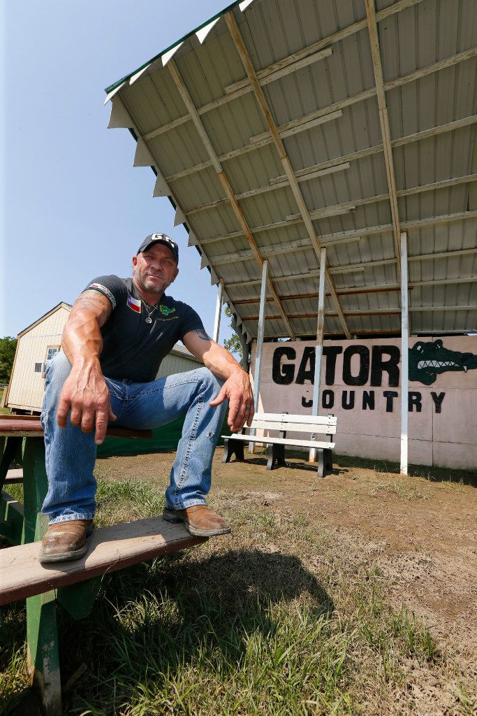 Wading in chest high water he wanted 100 gators to swim toward him